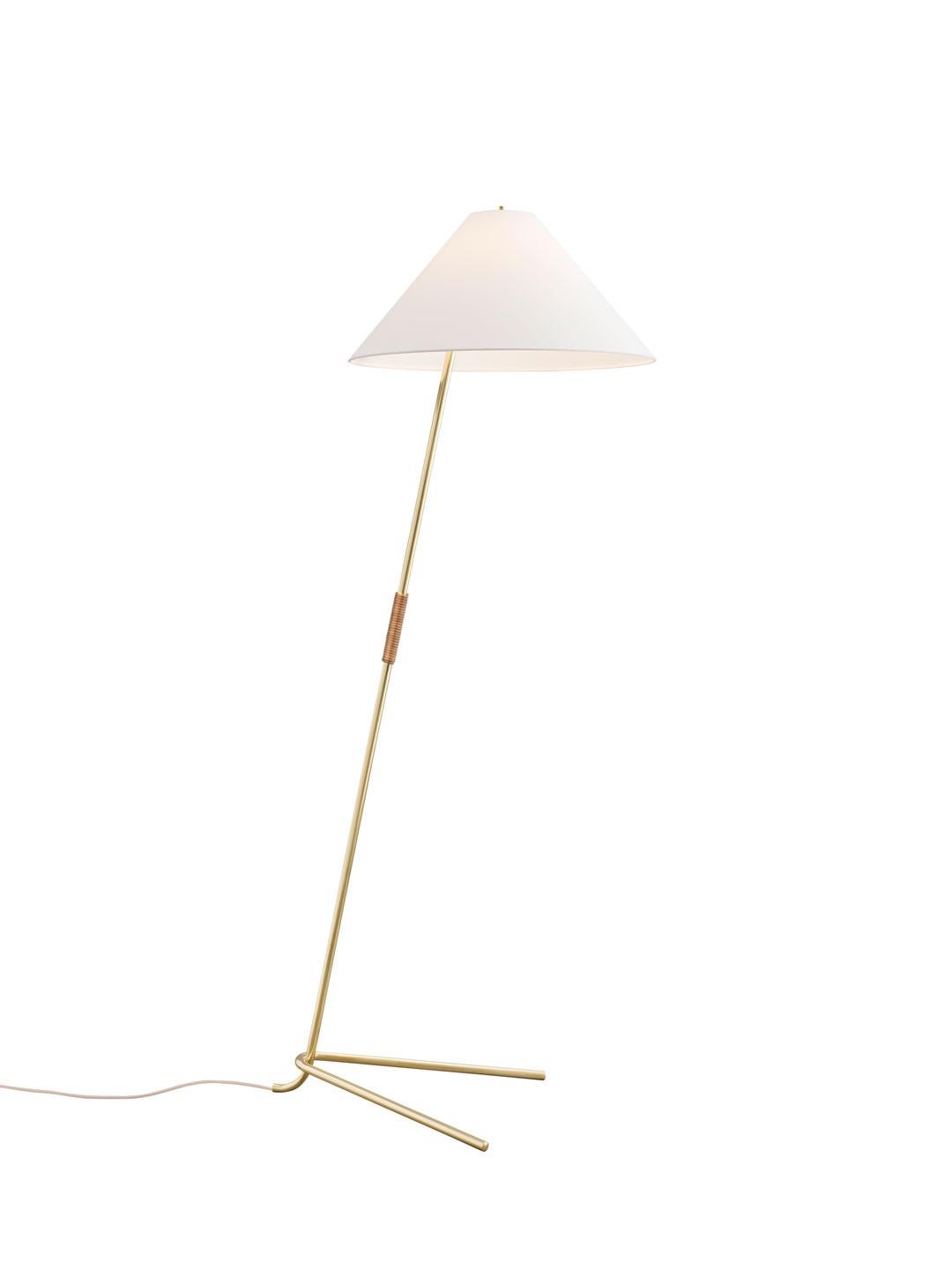 Floor lamp 'Hase BL' originally designed in 1952 by J.T. Kalmar, Austria, executed in polished brass and partly wrapped in a tactile leather to serve as a grip for easy repositioning. 
'Have BL' provides directional and ambient light thru it's