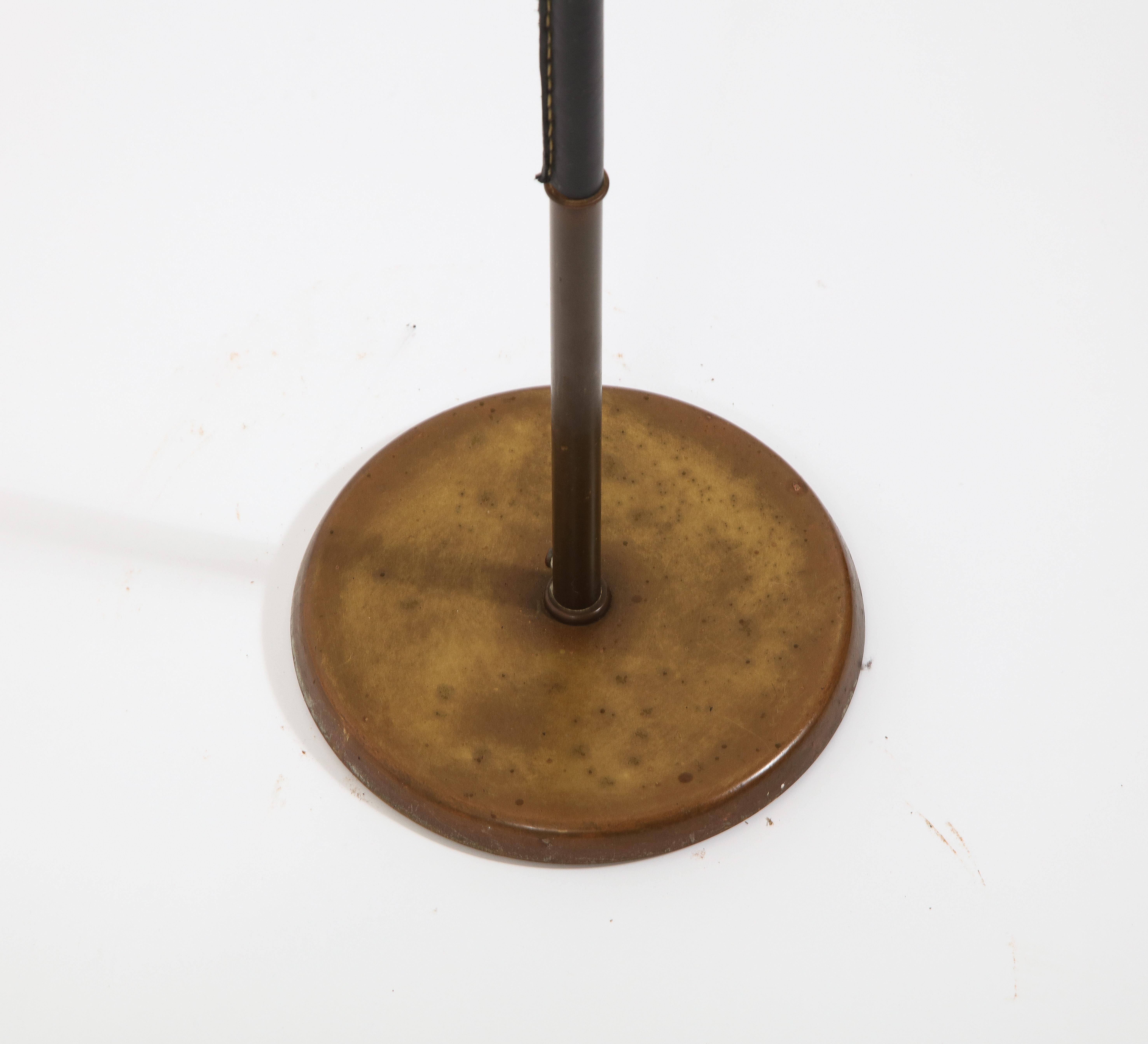 Minimal standing brass lamp with a leather-wrapped stem. Original patina. Shade is for photographic purposes.