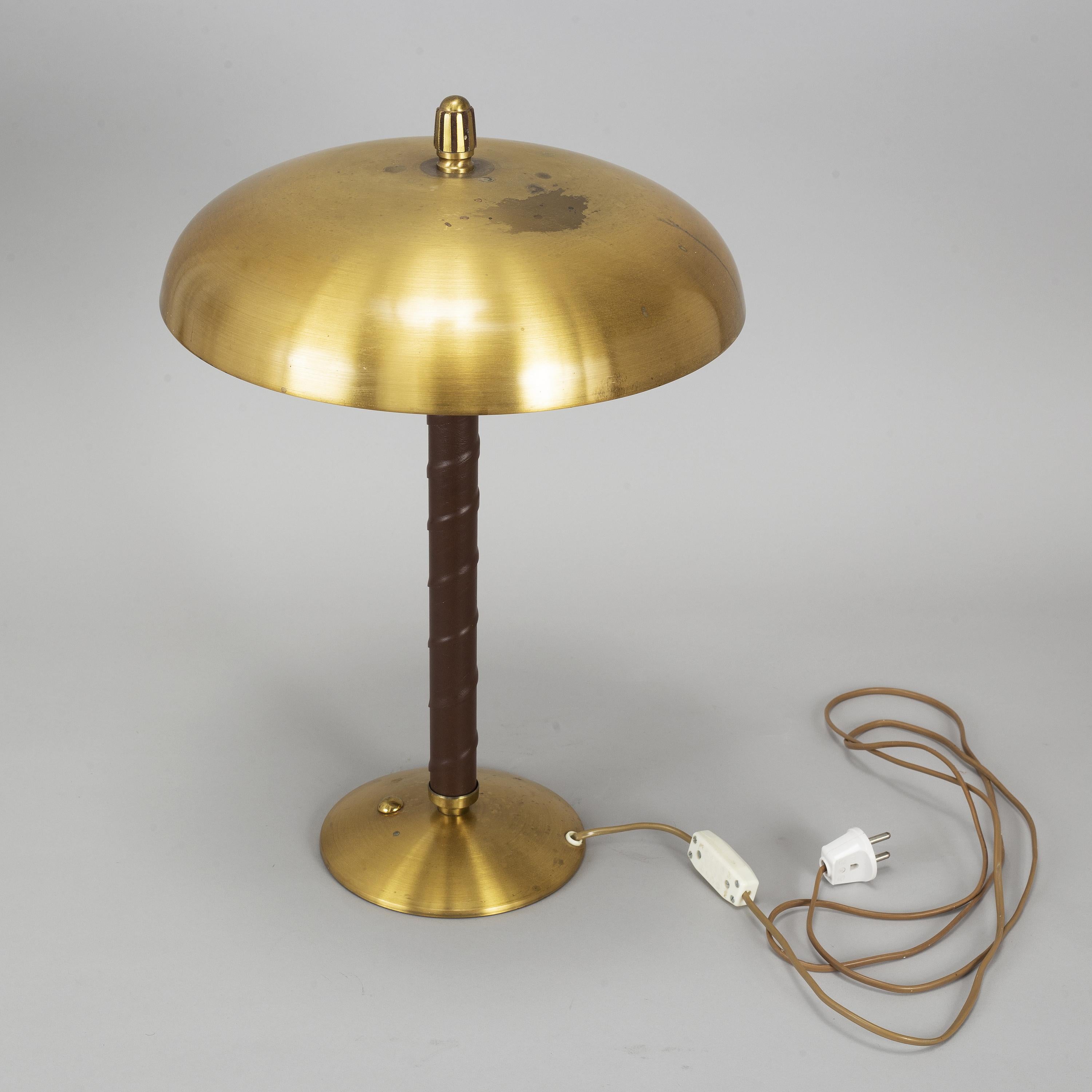 A model 5013 brass dome table light with stem wrapped in leather. 1940's. Presumably made in Malmo, Sweden.