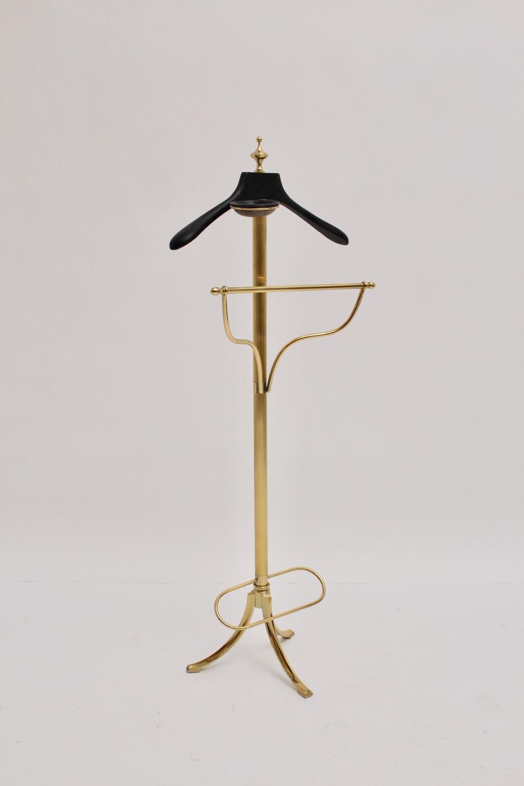 This beautiful and elegant brass valet was designed and manufactured in Italy.
The valet has a black leather covered clothes hanger and a black leather covered tray for utensils.
The valet features also a reling to hang up your pants. On the bottom