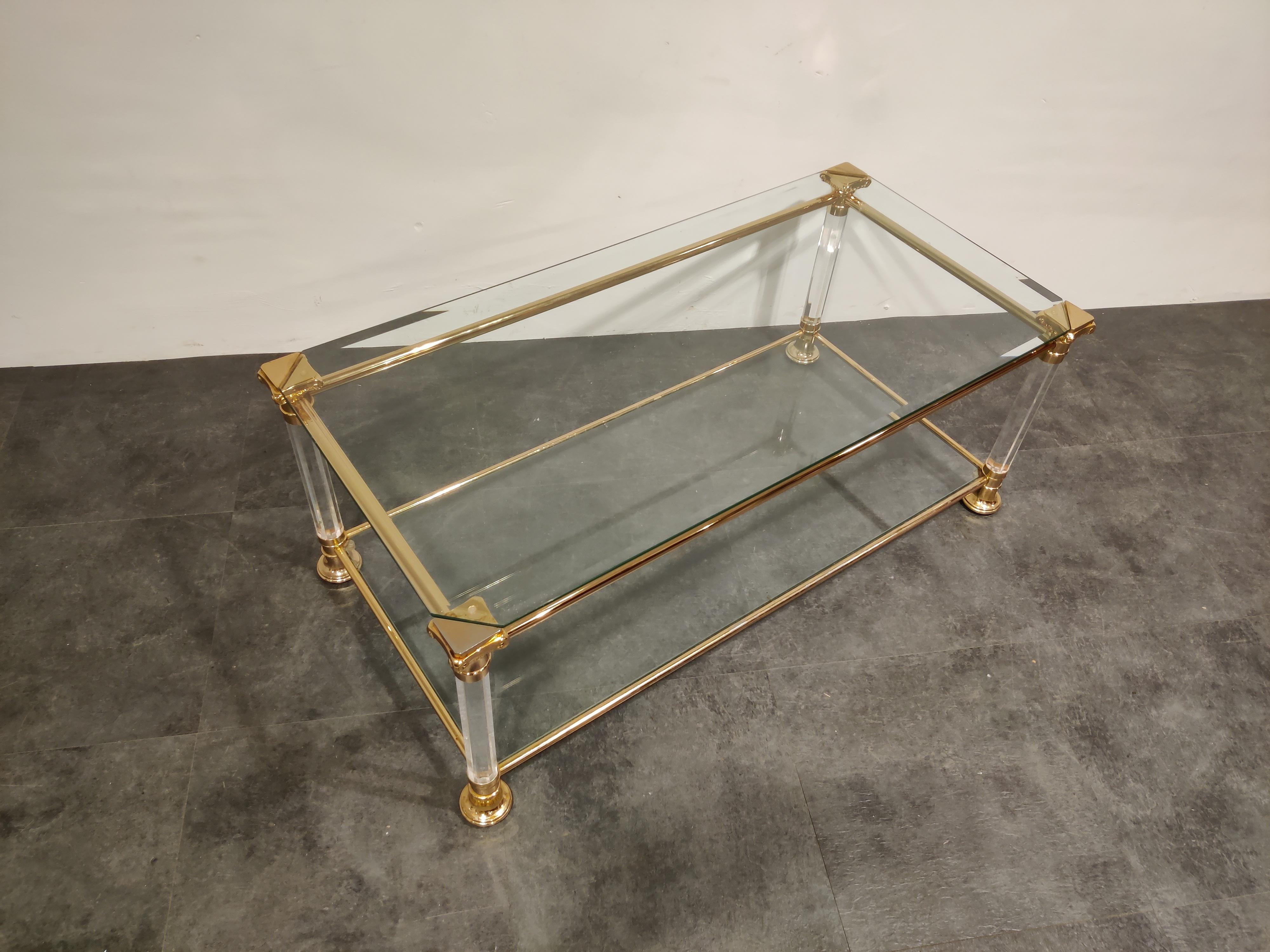 Vintage rectangular two tier coffee table made from Lucite and brass columns with clear glass tops.

1970s - France

Good condition

Measures: Height 57cm/22.44