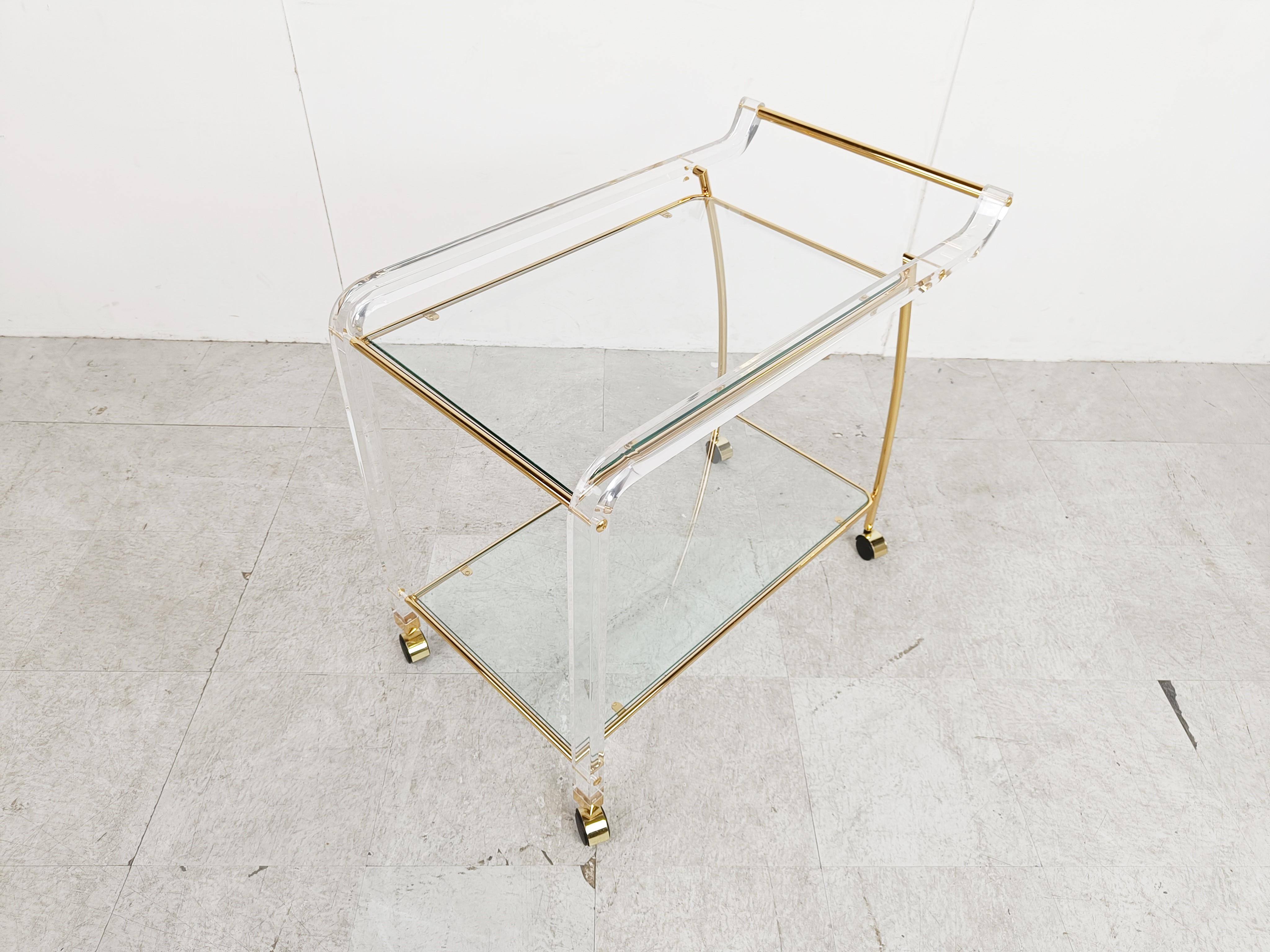 Elegant vintage brass and lucite serving trolley with clear glass tops.

1970s - France

Very good condition

Dimensions:
Height: 71cm/27.95