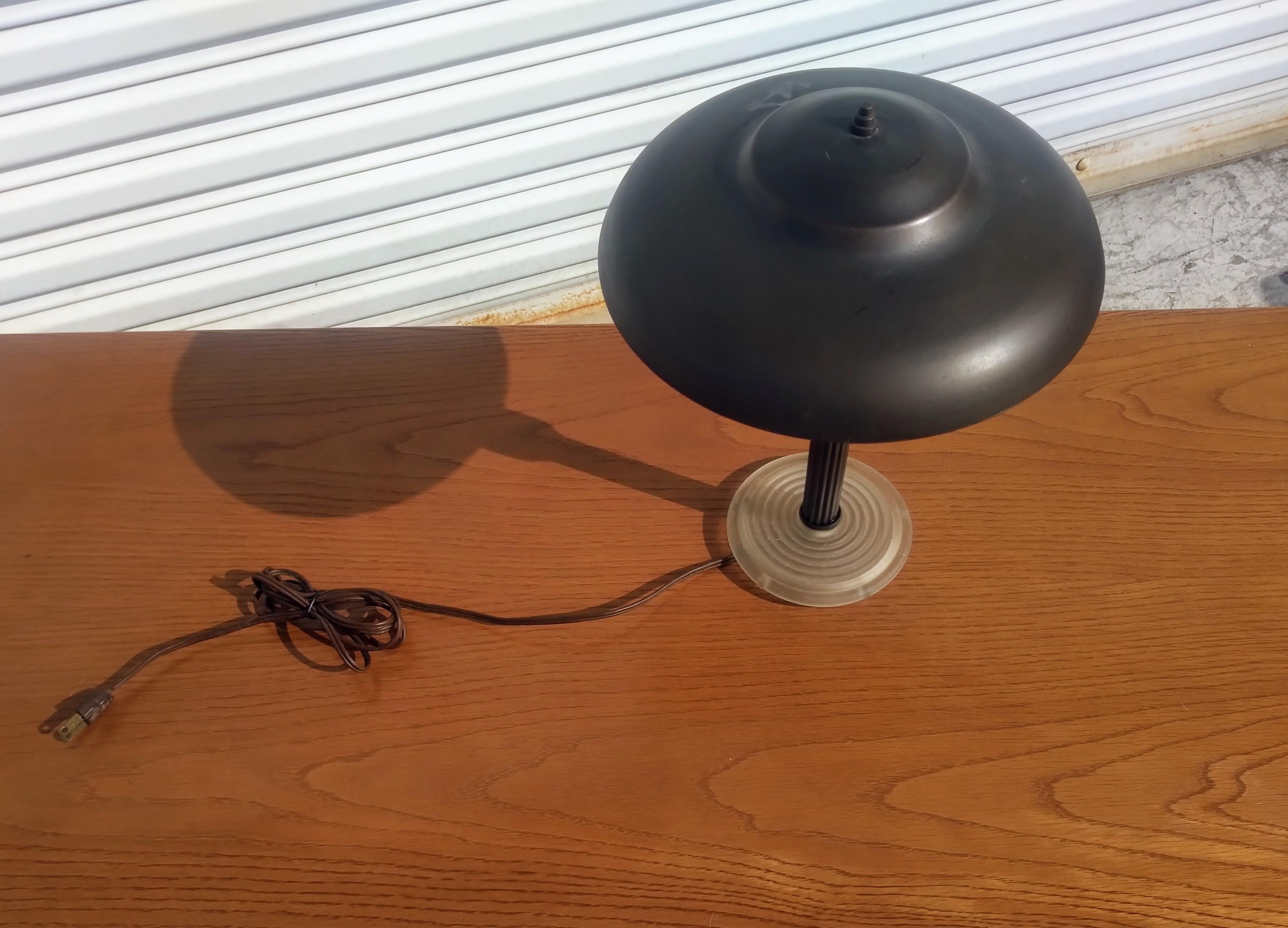 This is a mid century style table lamp. It's made to look like a flying saucer. The foot is made of lucite. The flying saucer shade comes with the lamp. The shade and the base is made of brass.

This lamp will make a great addition to any home or