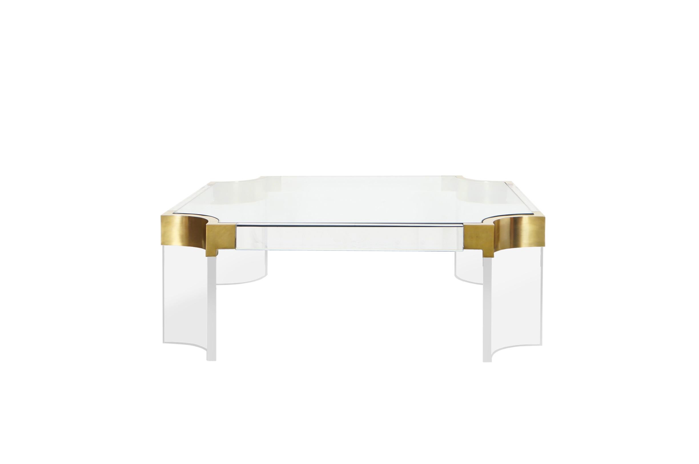 Exceptional Lucite and brass coffee table designed by Charles Hollis Jones for the Waterfall Line. The coffee table has emphasis on gracefulness, softness, and elegance.