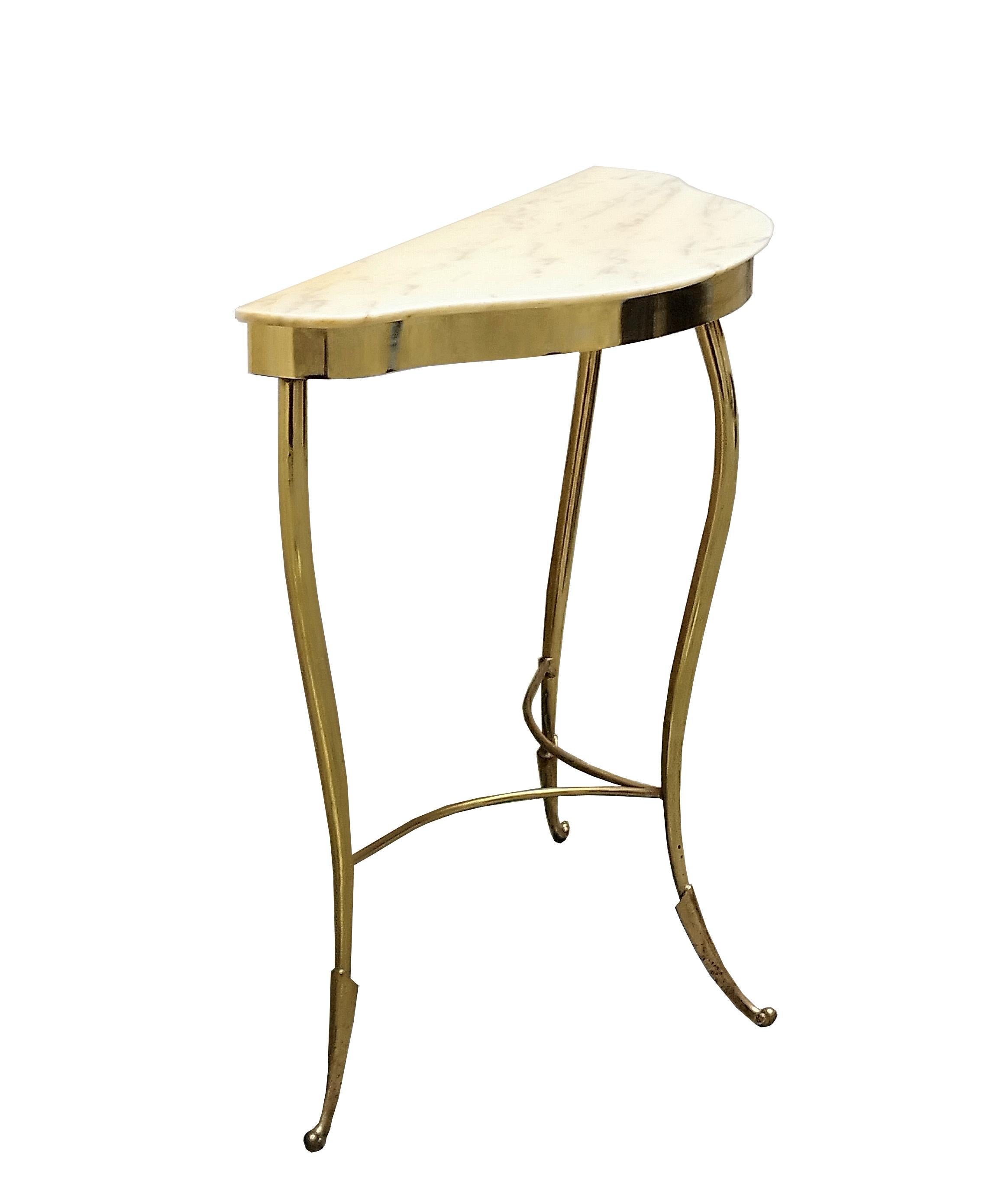Italian console table with a crescent-shaped design, dating from the important mid-century modern design period of the 1950s. This piece is exquisitely crafted with its triad of tapered brass legs and marble top. 
