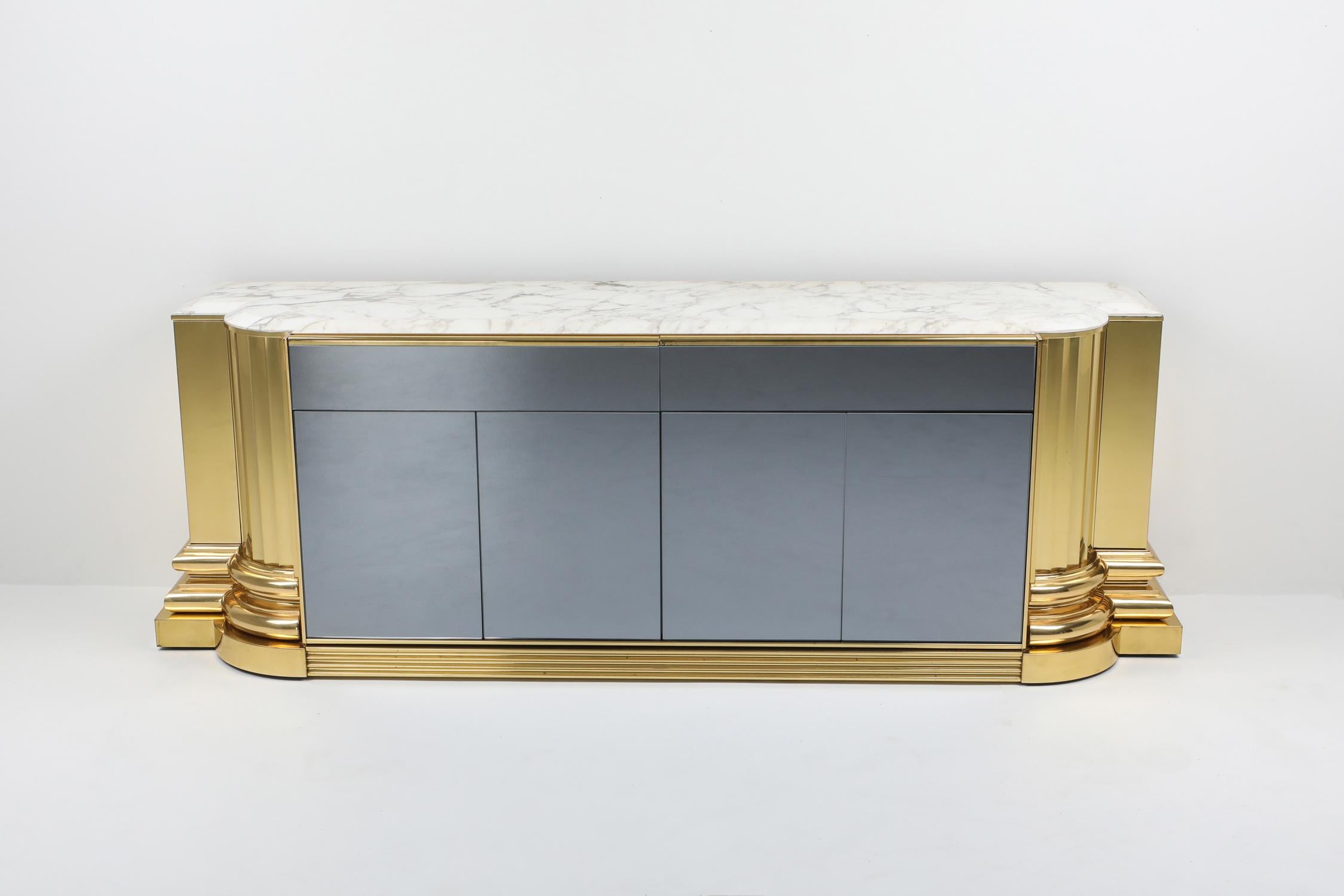Hollywood Regency sideboard by Sandro Petti for l'angelometallarte.
A true high end piece which shows in the top level of finishing.

A modernist roman style sculptural work with four front doors in mirrored glass complemented with four top