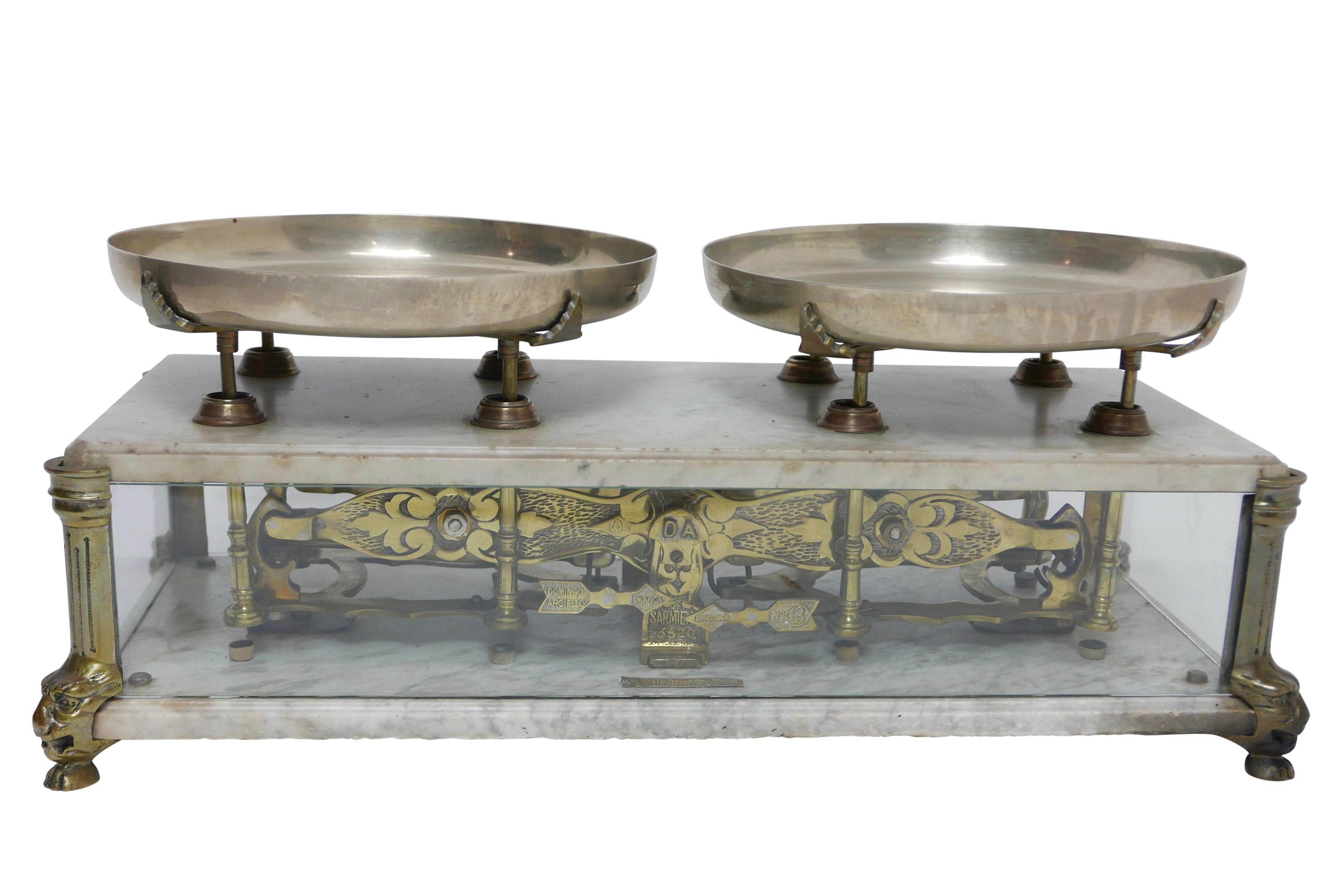 Elaborate marble, glass, and brass Culinary balance scale, the weigh pans of nickel silver sitting on brass supports. In original condition with makers plaque reading; Domingo Arcielio Argentina.