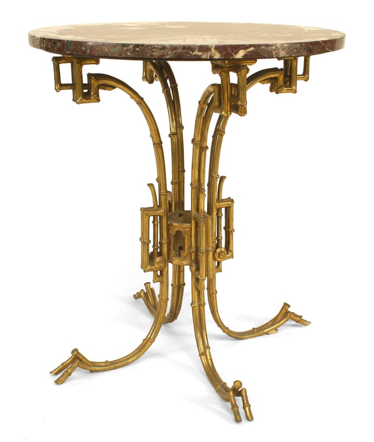 English Regency-style (19/20th Century) brass end table with faux bamboo base supporting a round rouge marble top.
