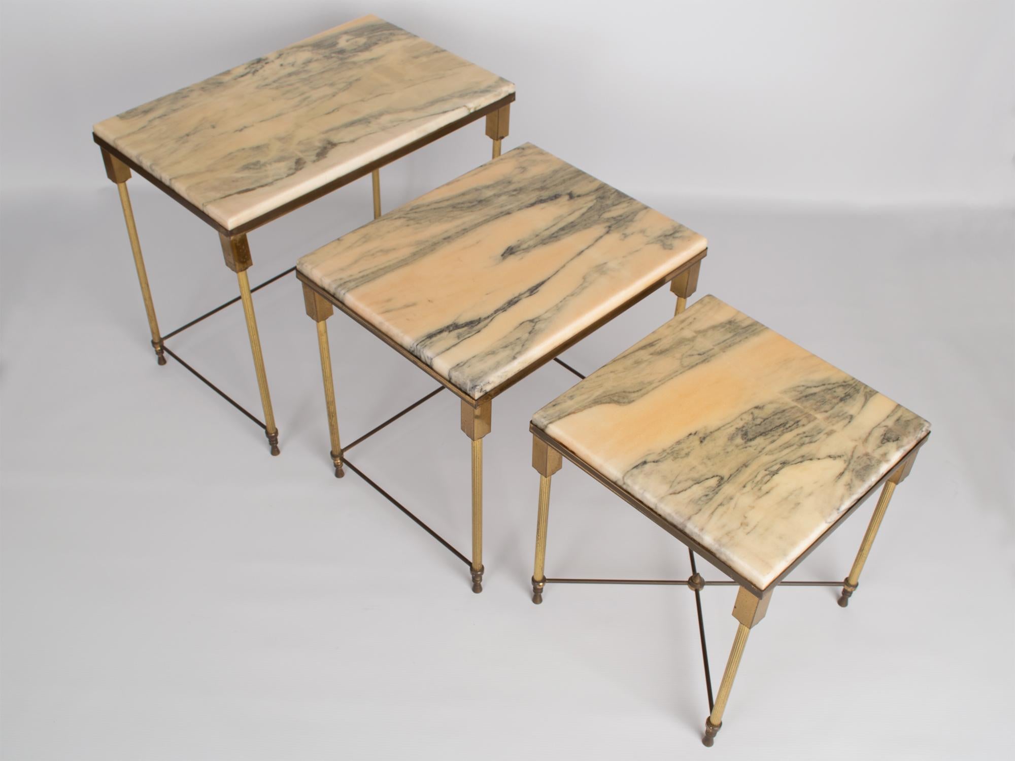 Brass and marble nesting tables by Maison Jansen, France, circa 1940.
Very good condition commensurate of age. Nicely patinated consistent with age.