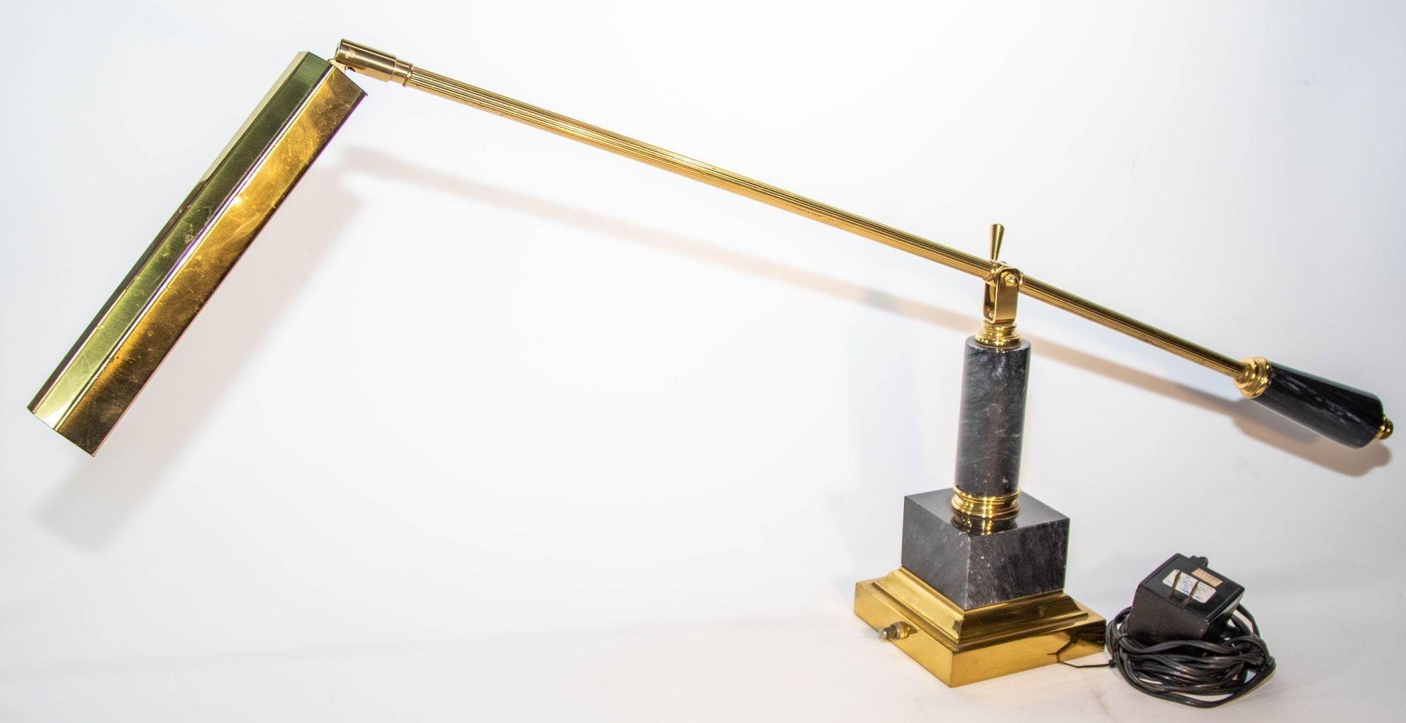 1980's Brass and Marble Rotating Table Lamp.
Brass finish Articulating Desk Lamp 1980s.
Vintage brass and marble piano lamp.
Heavy and substantial, fully adjustable.
Articulates and pivots in several directions.
Mid-Century brass swing arm table or