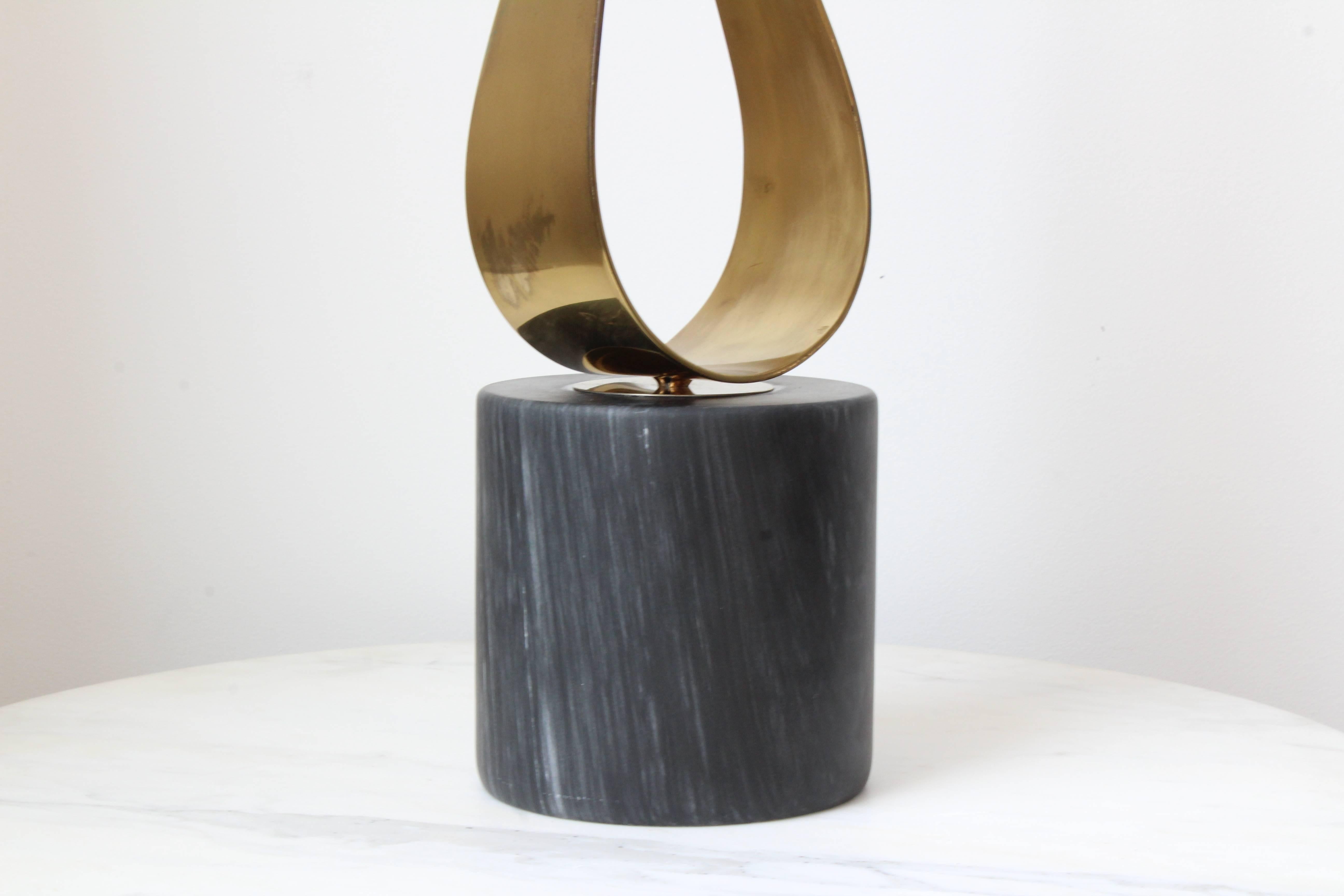 A fabulous 1970s whimsical brass sculpture on a honed marble base. Signed by Curtis Jere.