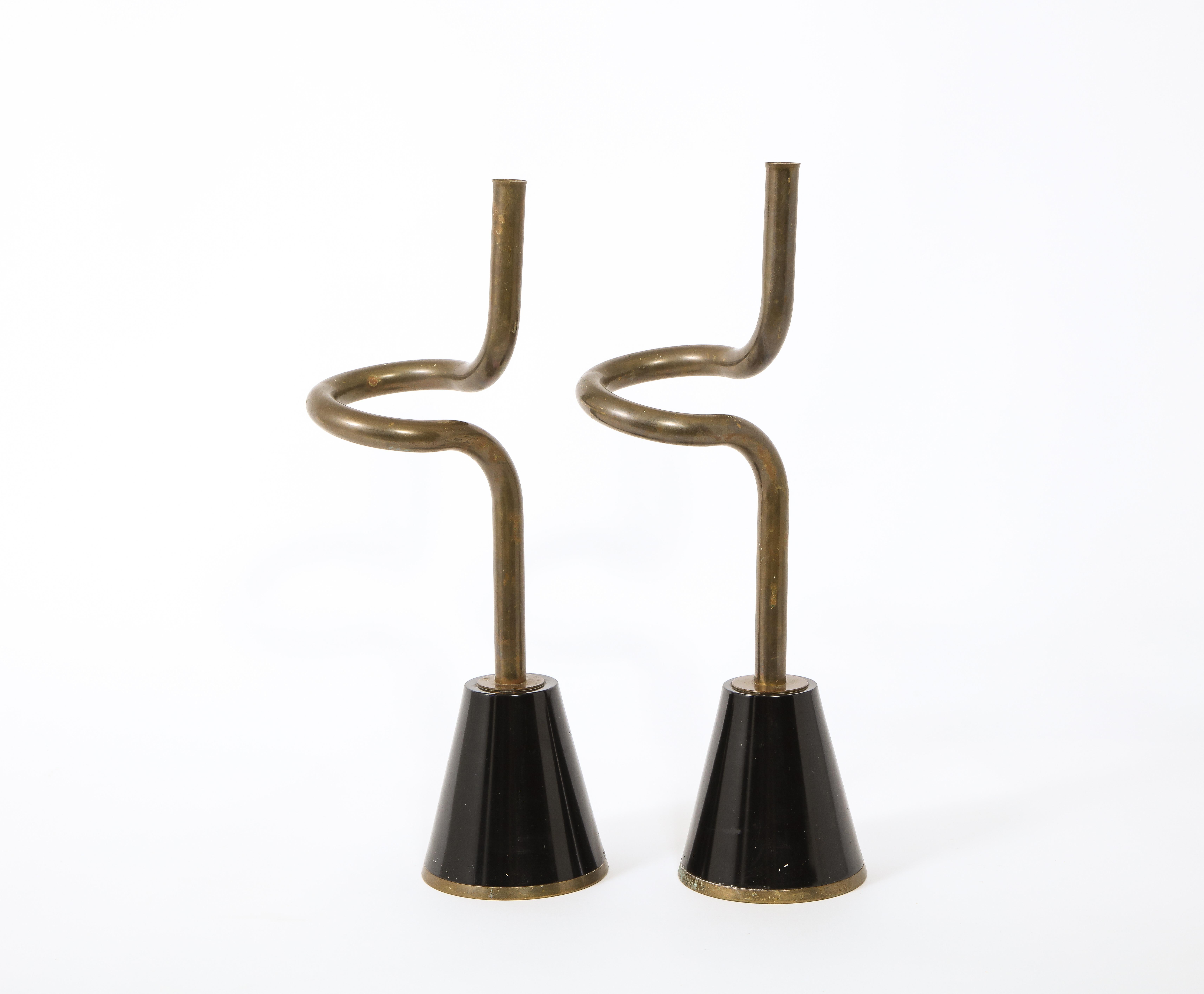 A large pair of spiraling brass and black enameled metal candle holders, reminiscent of Dorothy Thorpe's work.