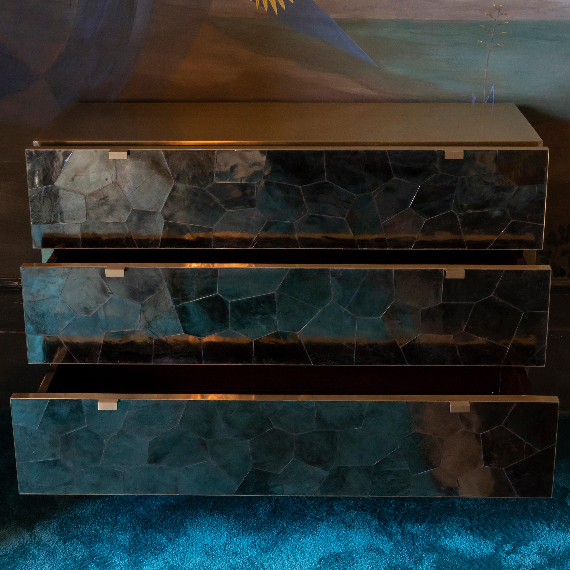 Contemporary wood chest of drawers or dresser covered in brushed brass and mica mineral sheets.