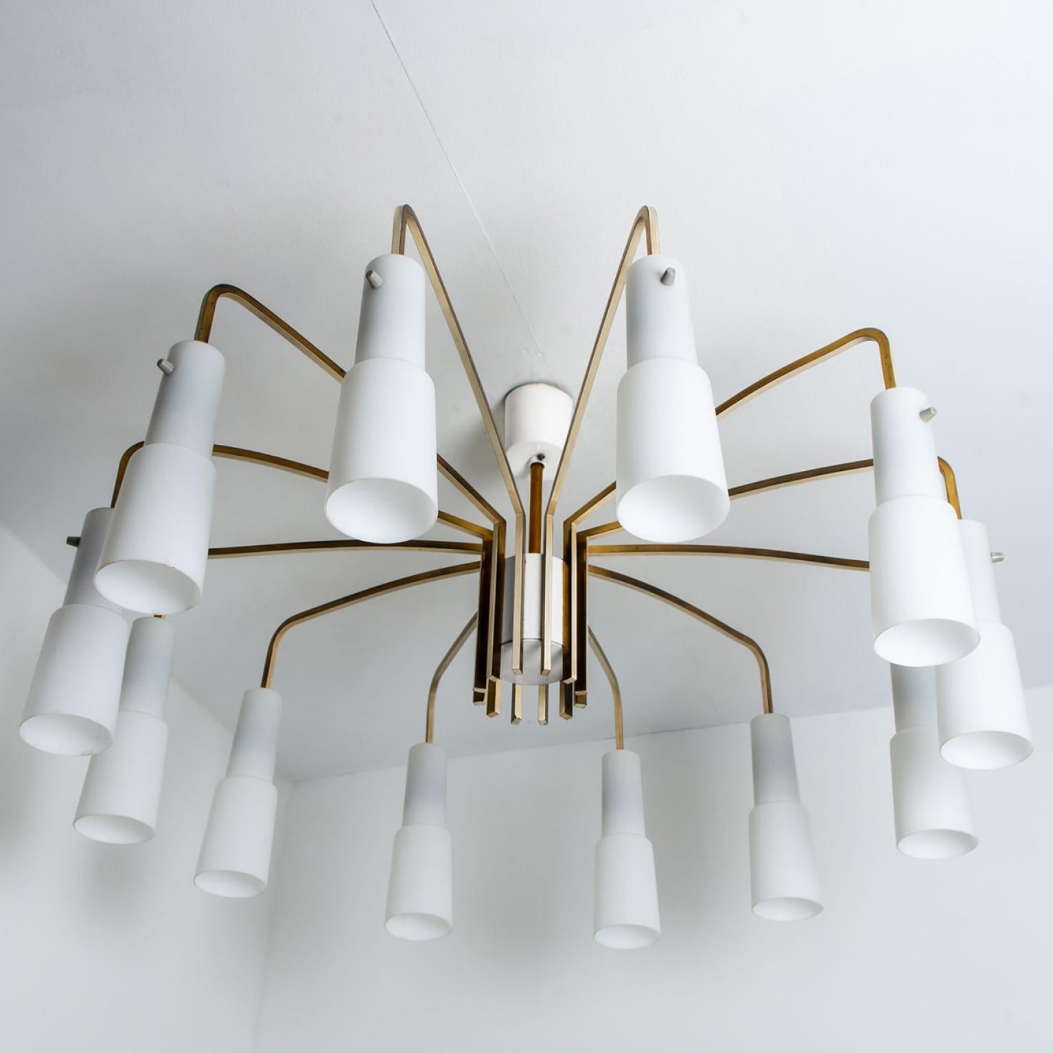 Impressive flush mount, designed and made by the company Hillebrand. The white milkglass shades are fixed on 12 brass 'arms'. Which makes it look like a spider shape.
Illuminates beautifully.

The flush mount is cleaned, well-wired and ready to use.