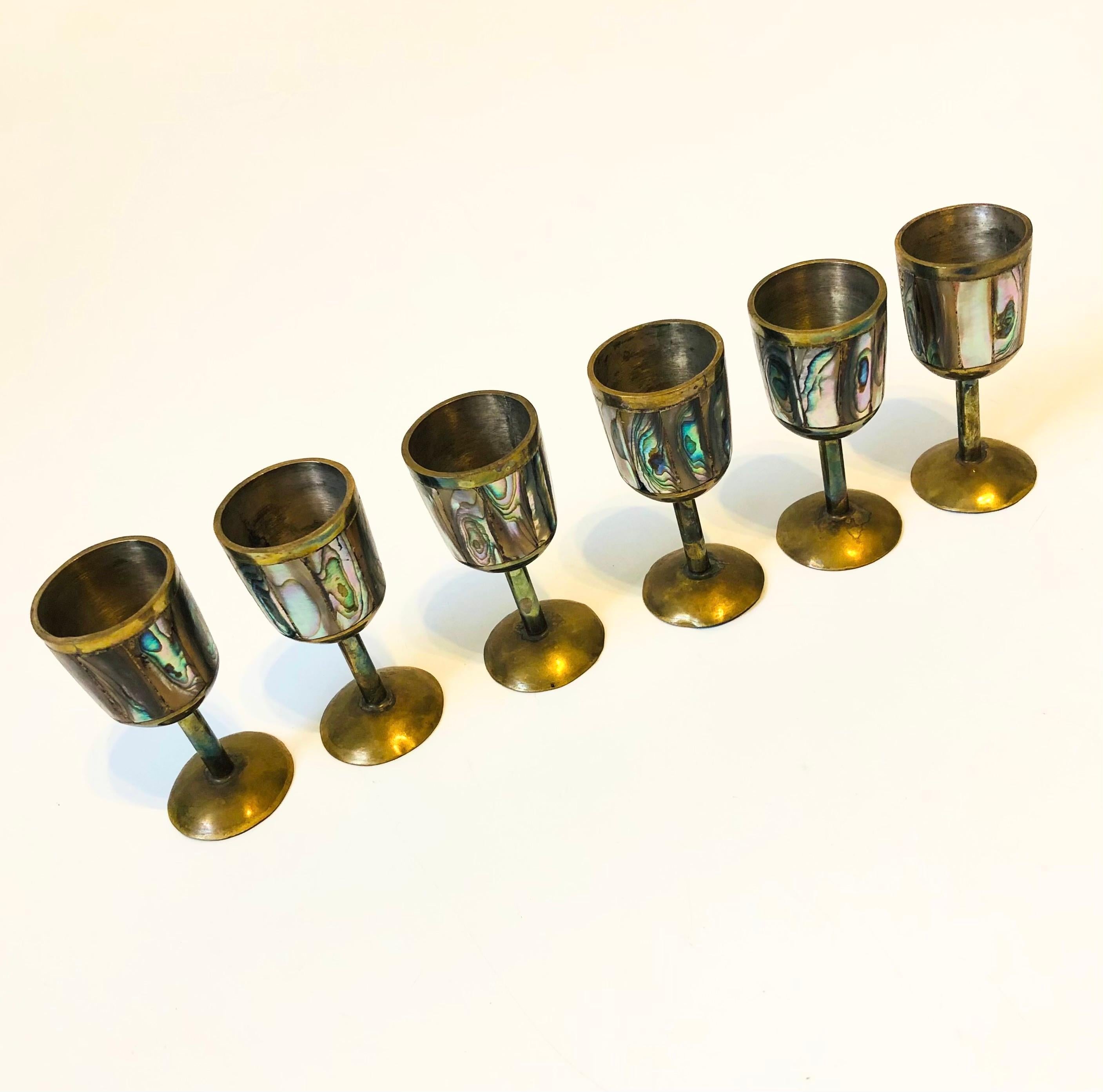 A set of 6 vintage cordials made of brass with mother of pearl inlay. Beautiful natural variation to the mother of pearl.

