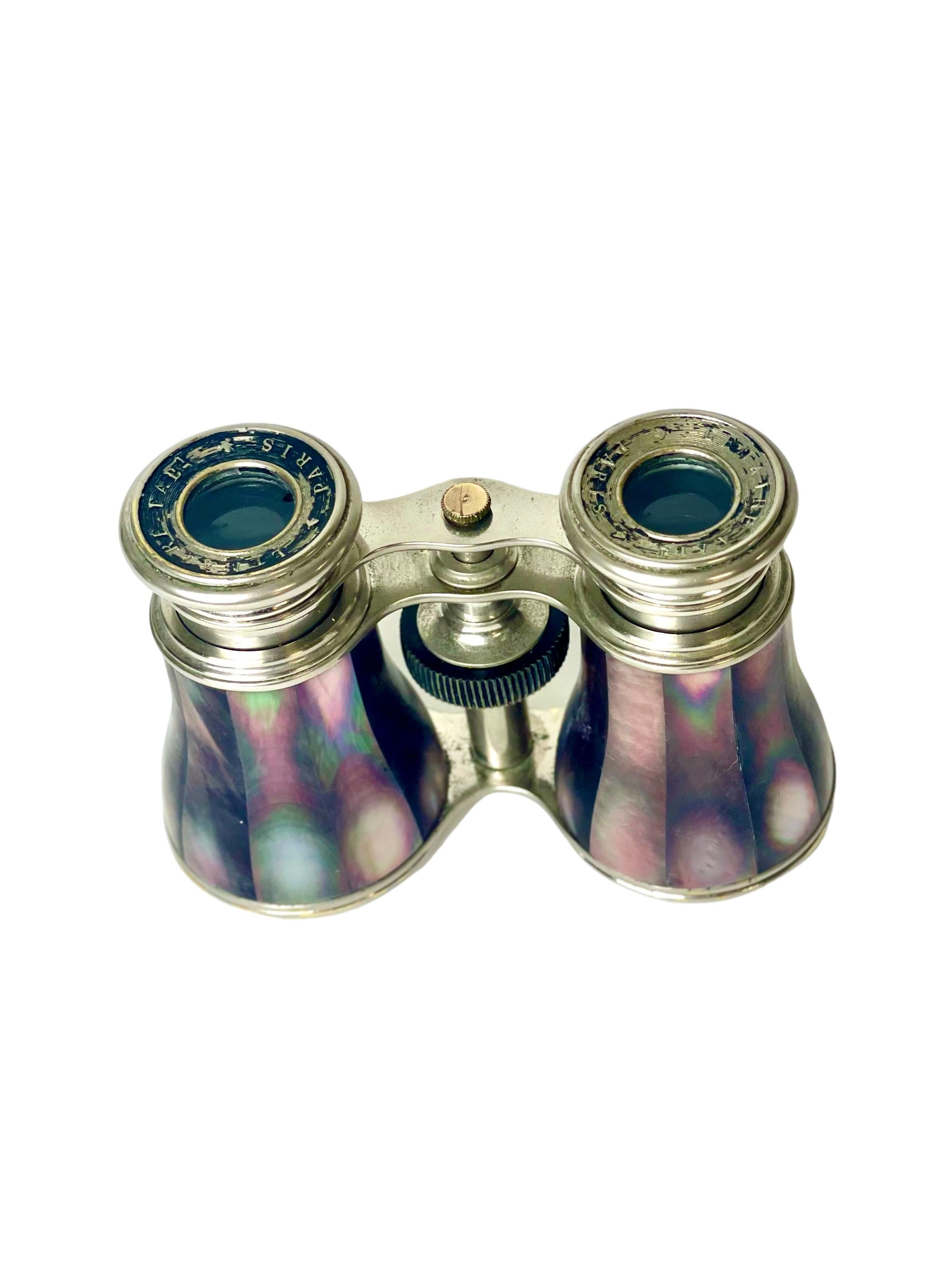 A pair of stunning miniature binoculars, or opera glasses, crafted from brass and clad in iridescent mother of pearl inlaid pieces. Dating from the late 19th to early 20th century, this practical accessory was a must-have for any member of the