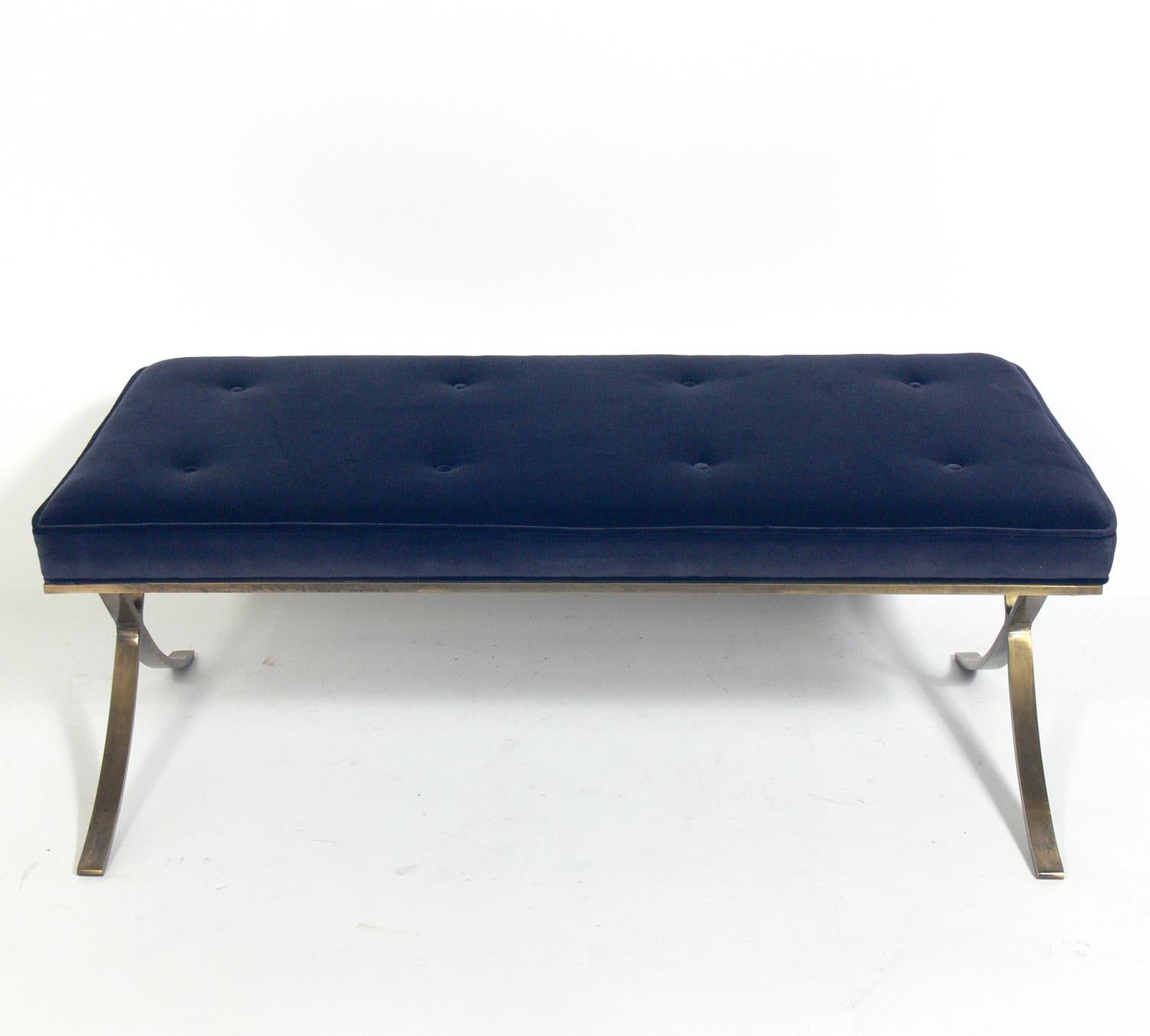 Brass and navy blue velvet Barcelona bench, after a design by Mies van der Rohe, American, circa 2000s. Recently reupholstered in a navy blue velvet over the patinated brass plated metal base.