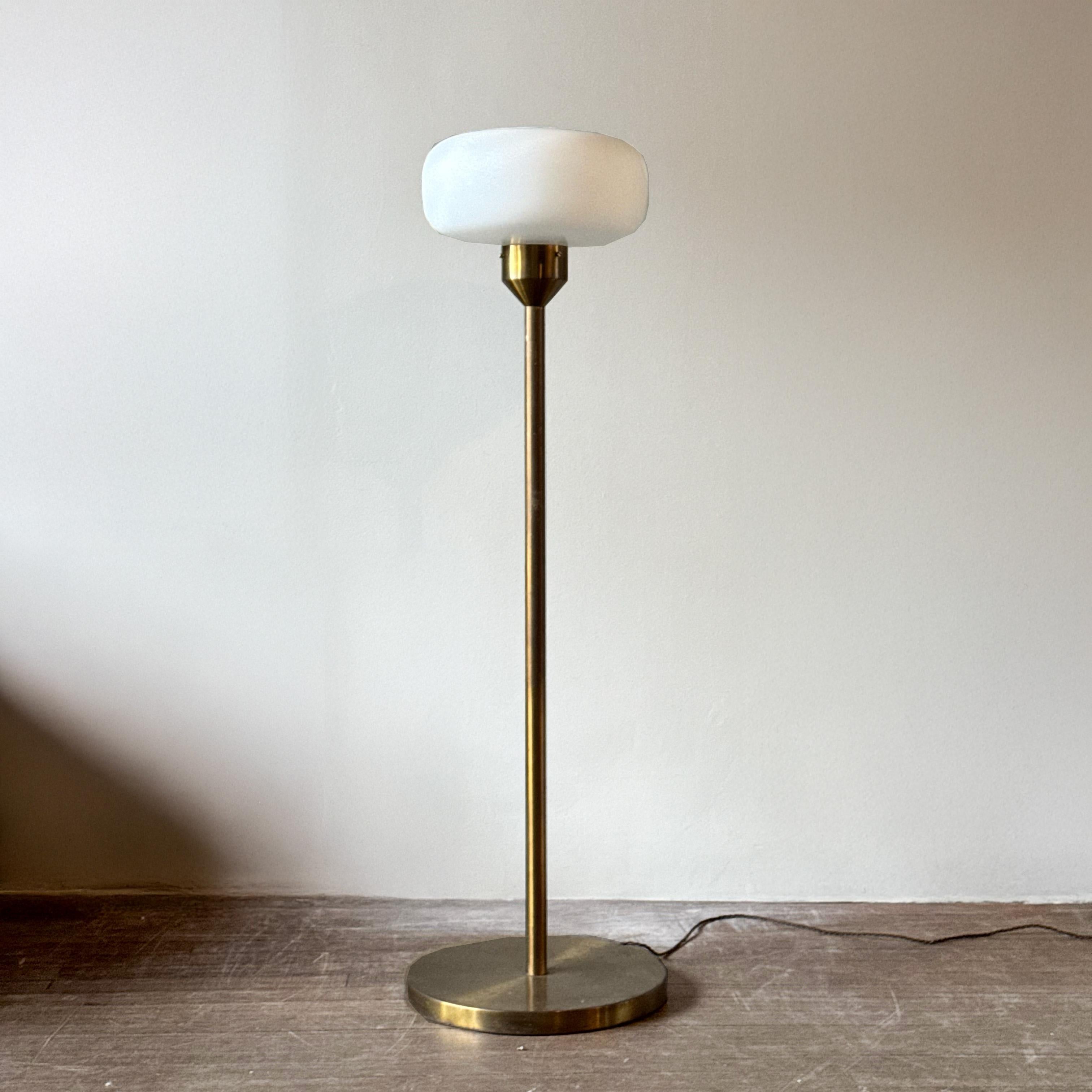A brass floor lamp with opal-glass shade designed for the Hotel Praha during the 1970s. 

Commissioned by the Communist Party in Czechoslovakia, construction began on the Hotel Praha in 1975. Beyond hosting the communist delegation, one of the