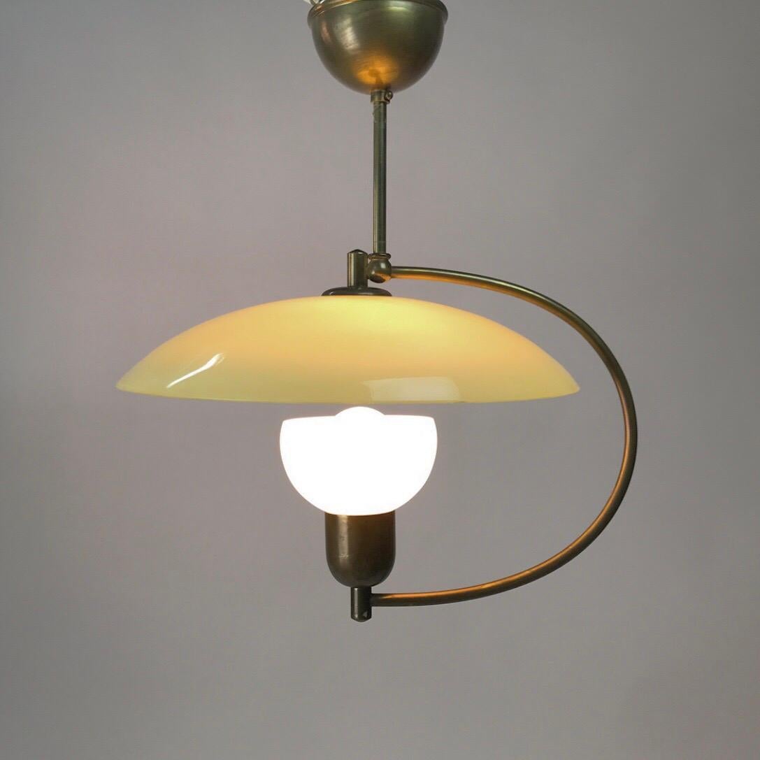 Classic 1950s Stilnovo era opaline glass pendant with original canopy. 

To different opaline glass pieces, one milky white center piece and the beautiful mint colored glass shade. 

Like the shade is floating the curved brass rod makes the