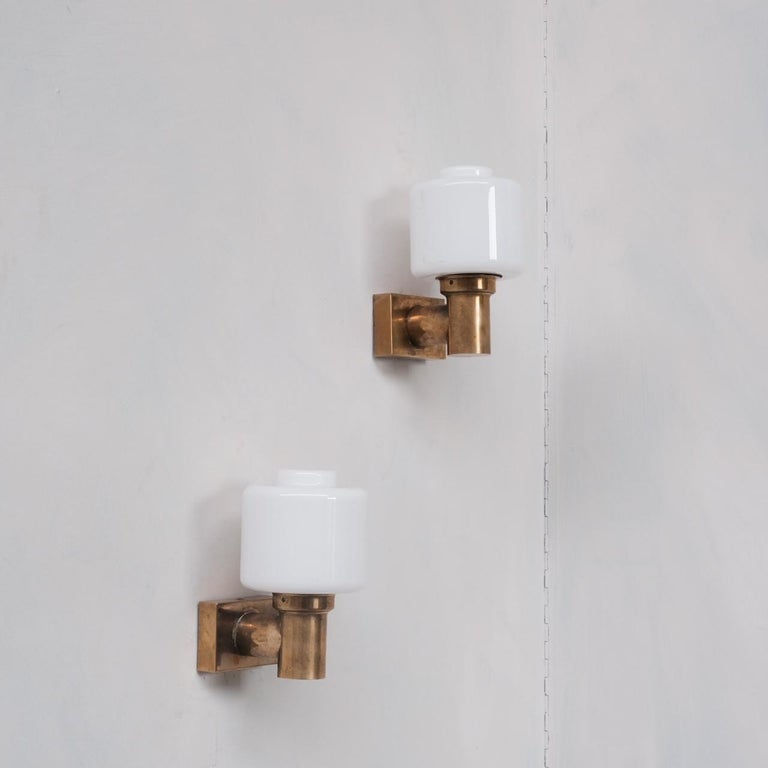 A set of up to three brass and white opaline glass wall lights. 

France, c1960s. 

Re-wired and PAT tested. 

PRICED AND SOLD INDIVIDUALLY. 

Location: Belgium Gallery. 

Dimensions: 14 D x 10 W x 18 H in cm. 

Delivery: POA

We can