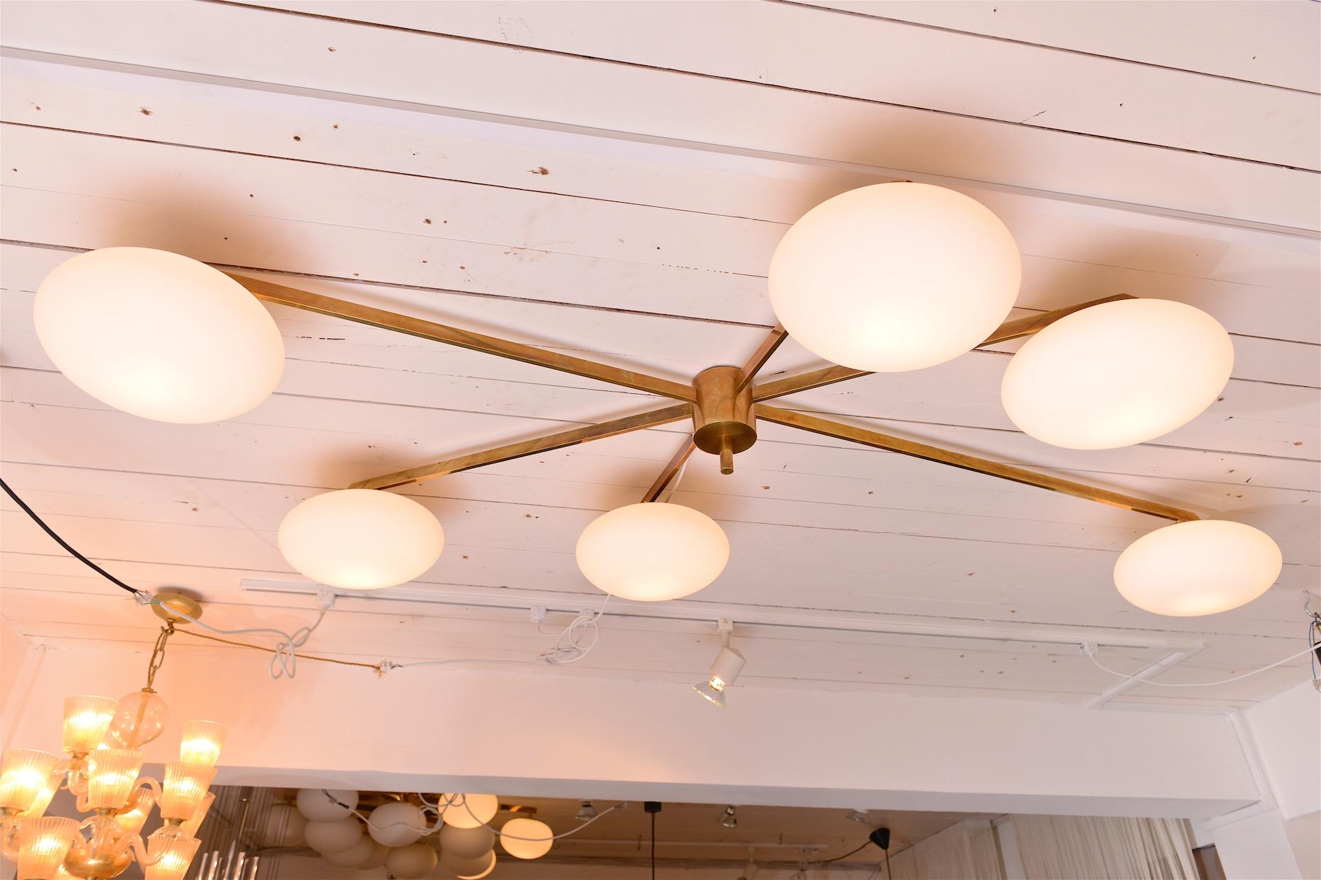 Angelo Lelli style ceiling light

Patinated brass with six opaline shades

A smaller three shade version also available

Also available in Chrome.

*** Please enquire for shipping... 
    