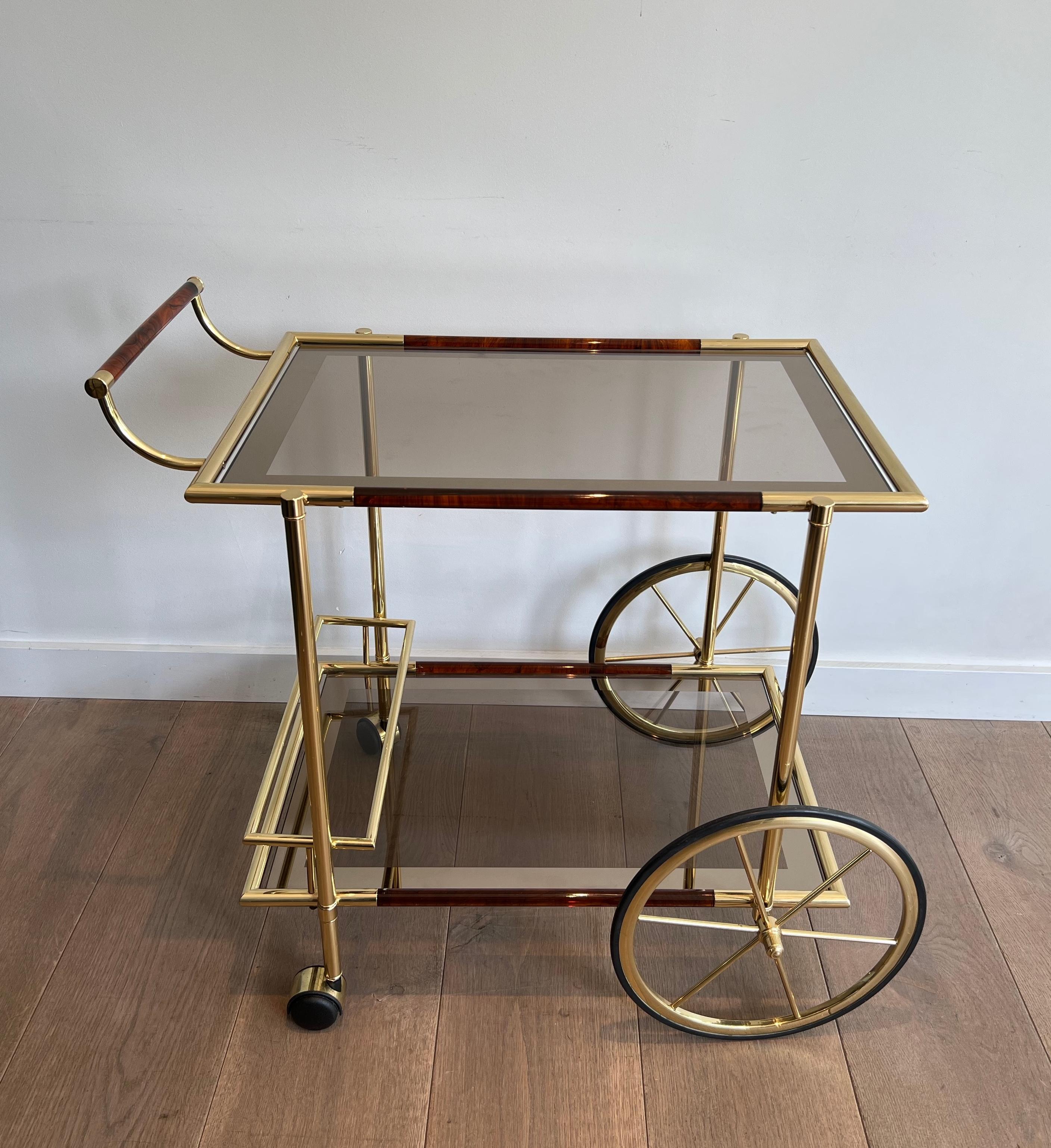 This very nice and unusual design drinks trolley. is made of brass and orange-red celluloid. Thi is a French work. Circa 1970