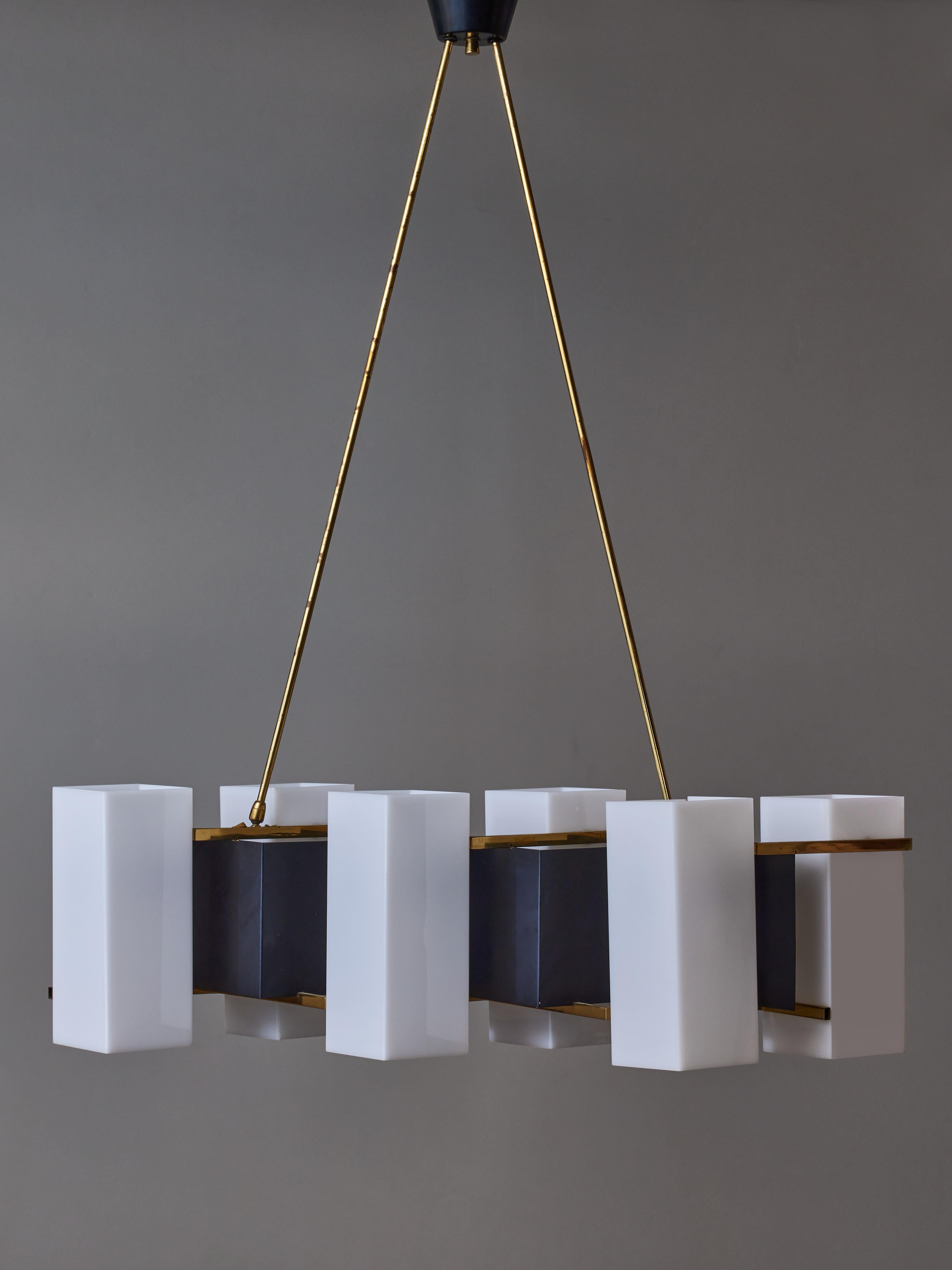 Mid-century chandelier by the Italian brand Stilux, this chandelier is made of six plexi rectangular sconces jointed together by a bent sheet of painted metal and brass structure.