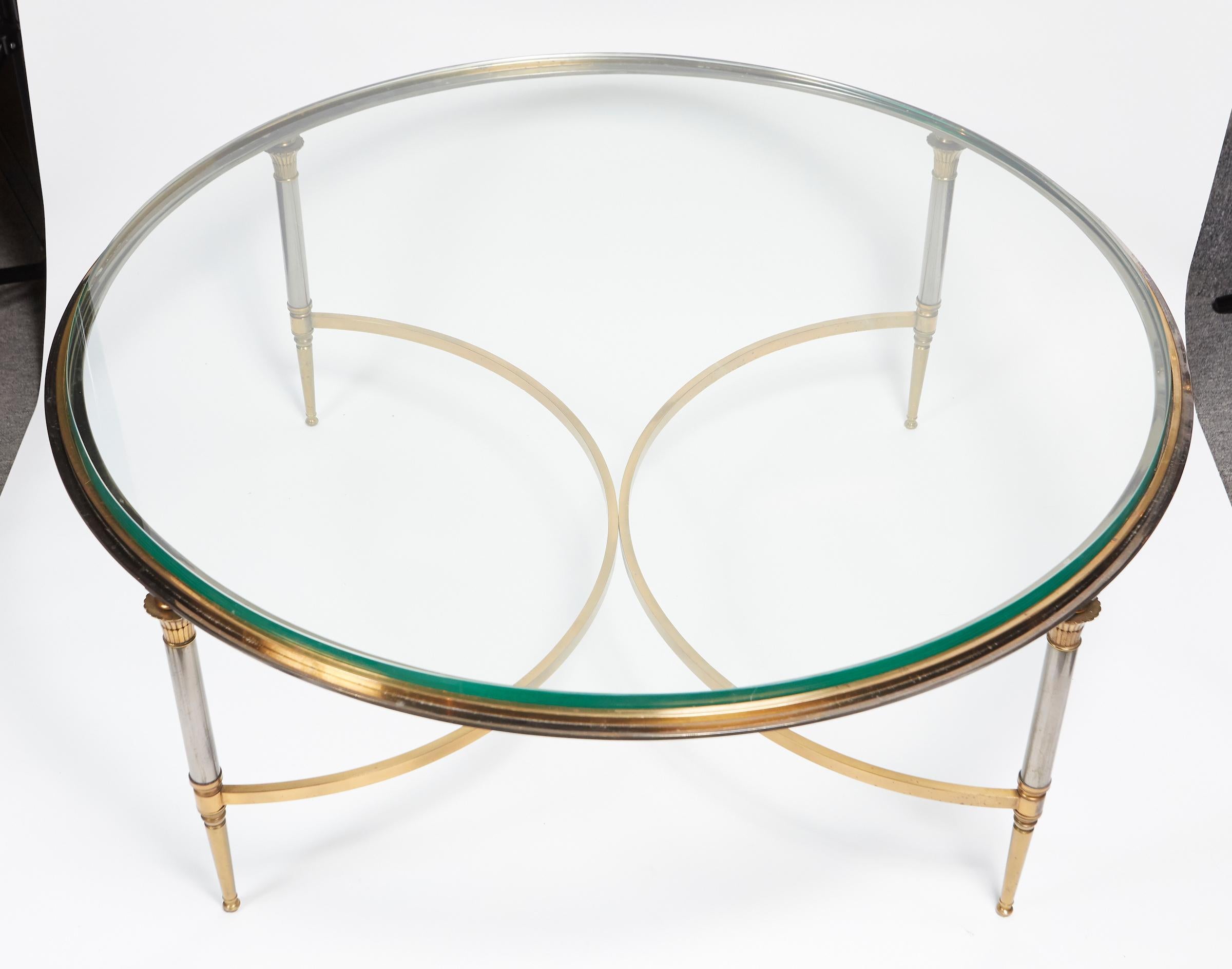 Brass and polished steal circular coffee table by Maison Jansen.