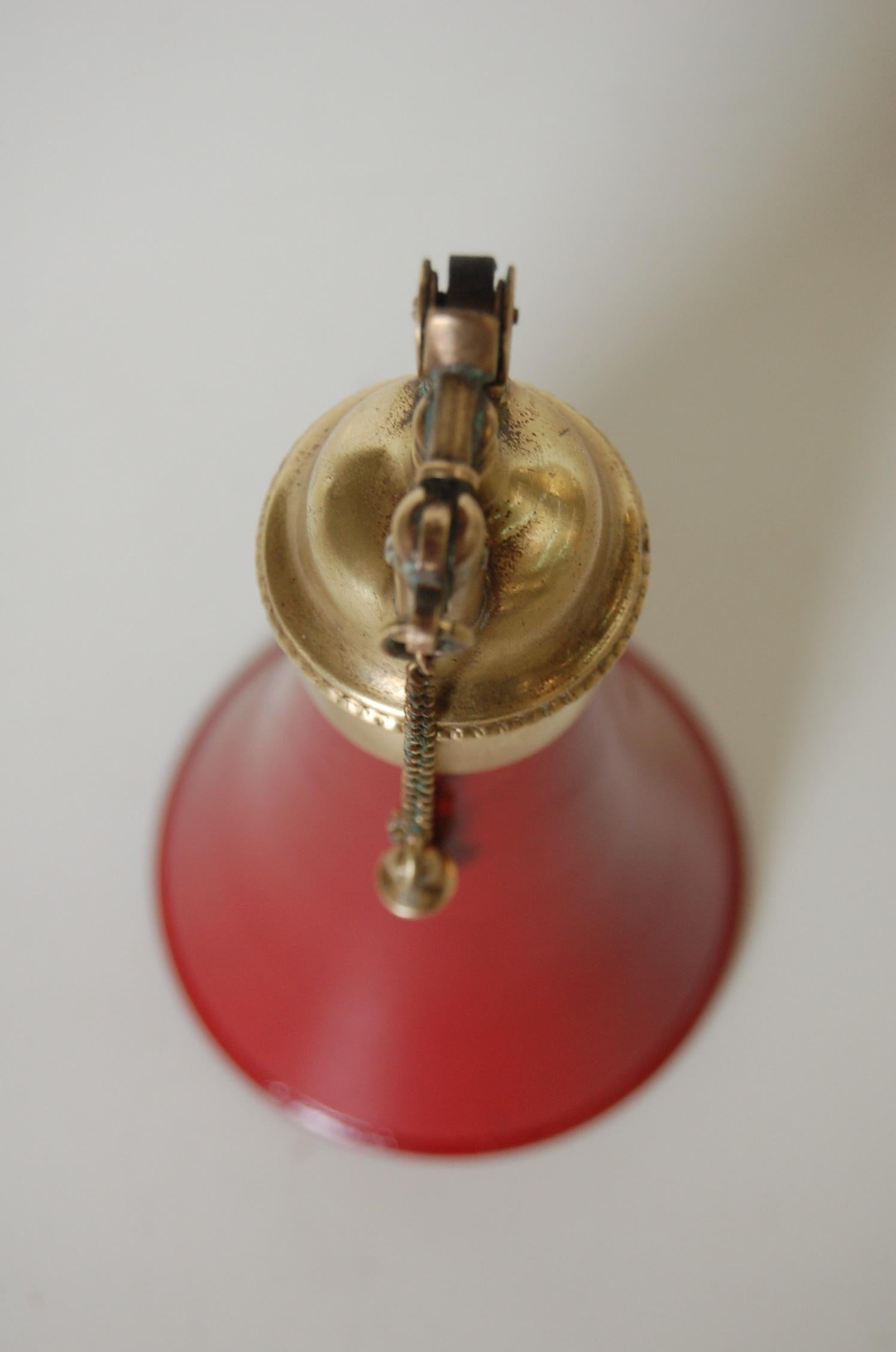 Early 20th Century Brass and Red Horn Shaped DRP Petrol Table Pull Chain Lighter by Zunder For Sale
