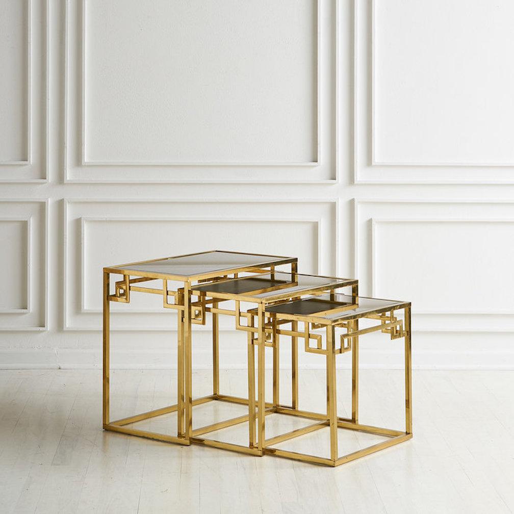 Set of three brass nesting tables with Greek key design and mirrored glass tops in an original rose gold tone. Italy, 1970s.

Dimensions: large - 24”W x 14.5”D x 21.5”H; medium - 21”W x 13.75”D x 19.5”H; small - 17.75”W x 13”D x 17.5”H.

