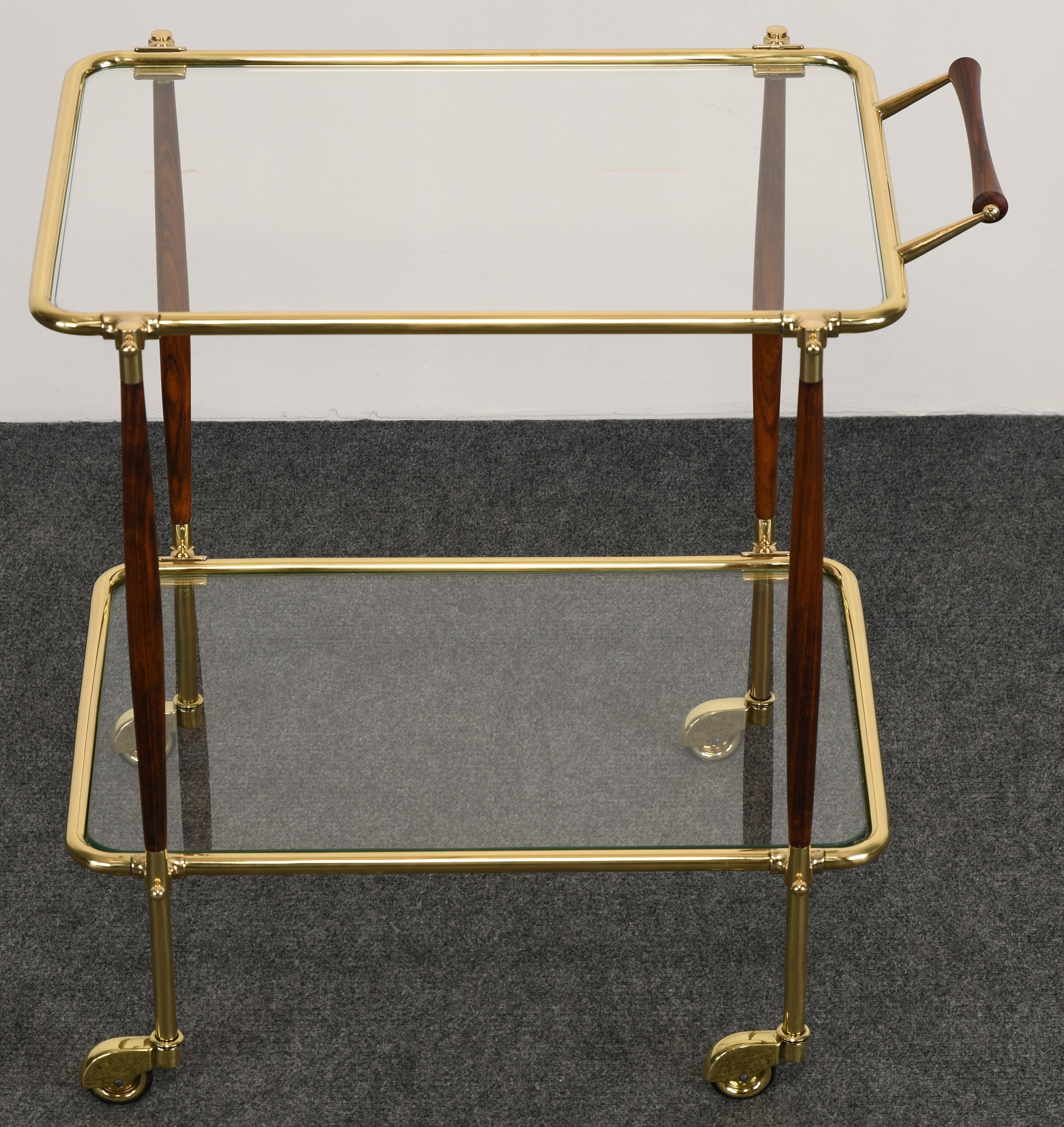 A gorgeous brass and rosewood bar cart or tea cart in the manner of Cesare Lacca. Newly restored finish. Glass is original but has some scratches, however, not distracting. 

Dimensions: 27.38