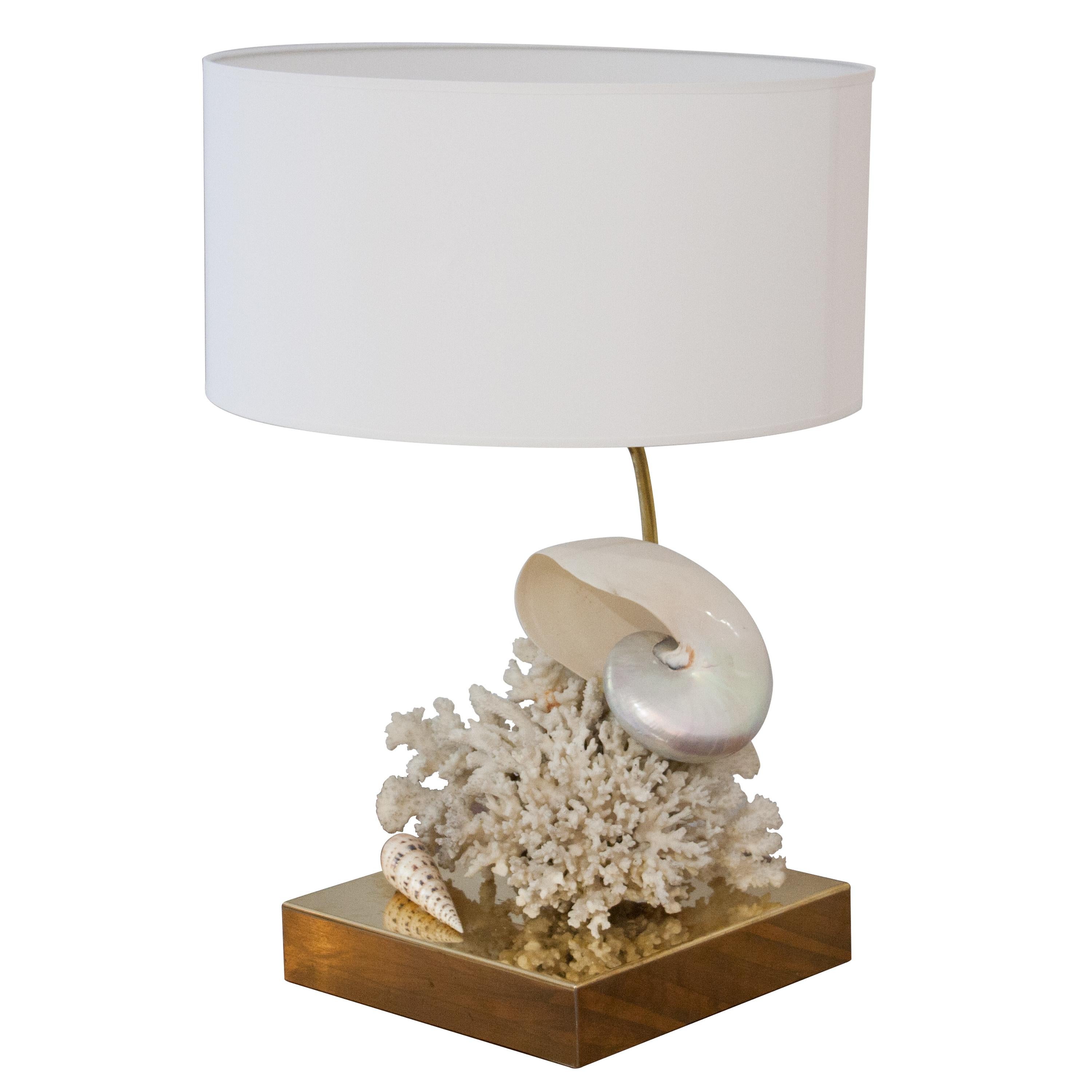 One of a kind hand-crafted pair of table lamps, with brass base and structure and natural seashells and corals. White lamp shade.