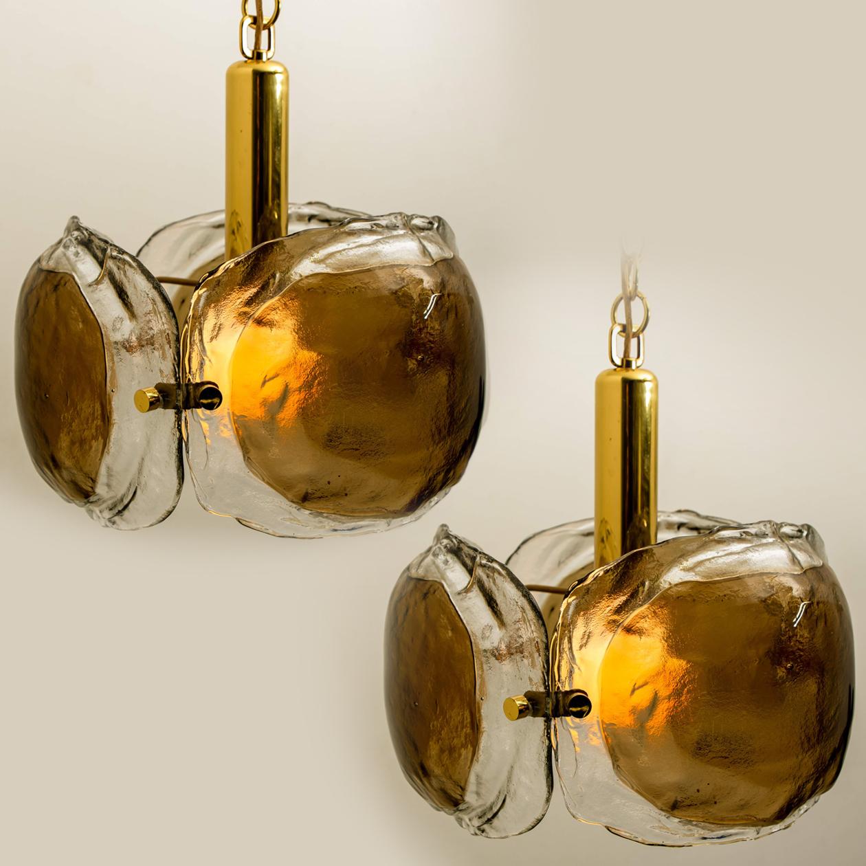 Two high-end pendant lights. Made of hand blown clear/ opal and brown (smoked) Murano glass on a messing hardware. Designed and manufactured by J.T. Kalmar, for Kalmar Lighting in Europe, Austria. Around 1960.
Minimalistic design executed with a