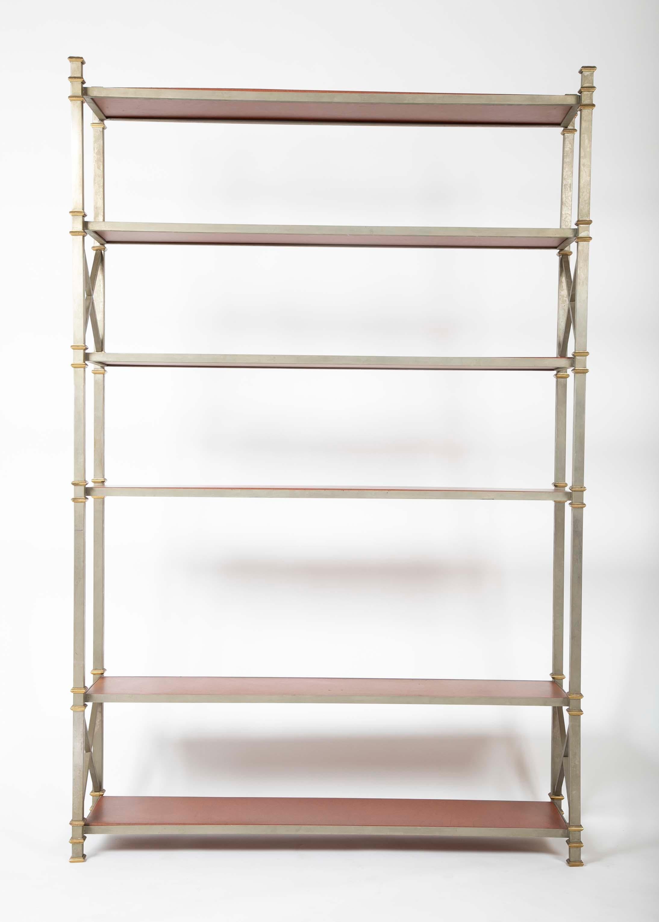 A Jansen style brass and steel etagere having handsome leatherette shelves. Designed by Barbara Darcy.