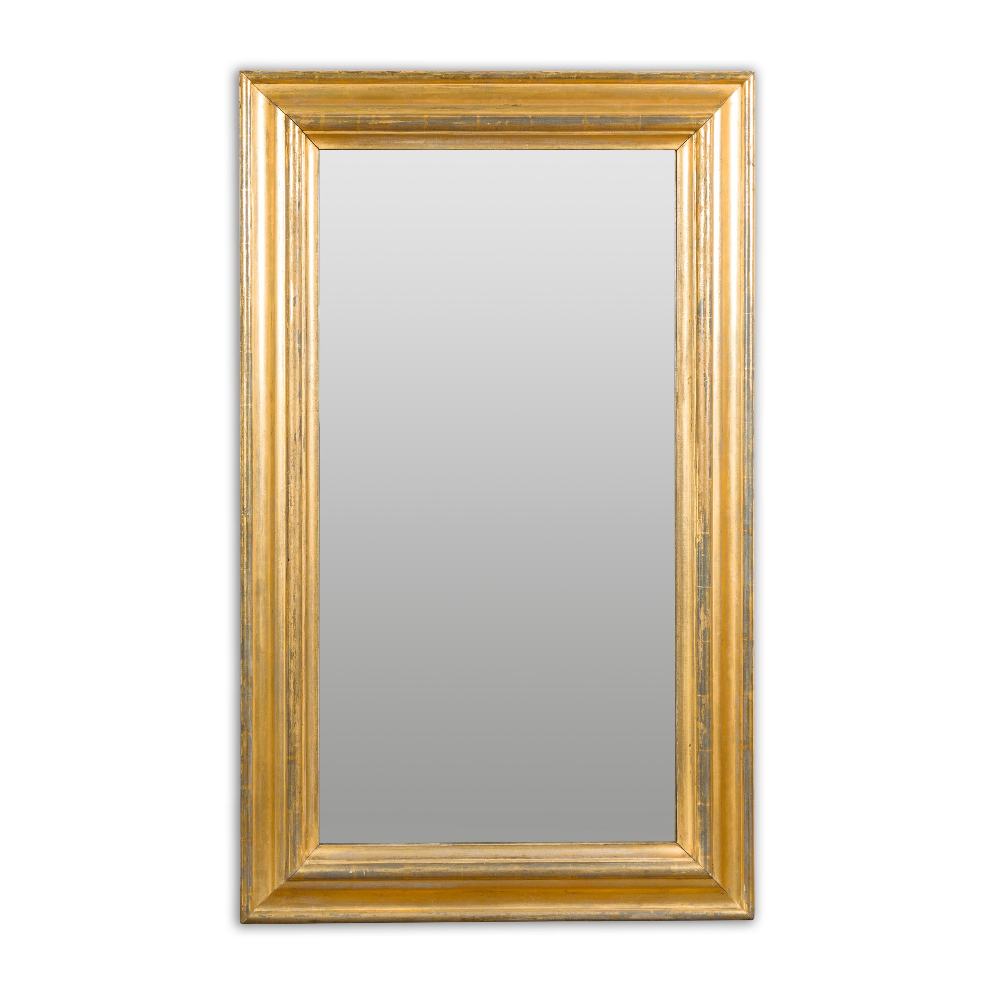An Italian brass and steel rectangular mirror from the 20th century with molded accents. Reflecting the allure of Italian craftsmanship, this 20th-century brass and steel rectangular mirror infuses any interior with elegance and sophistication. The