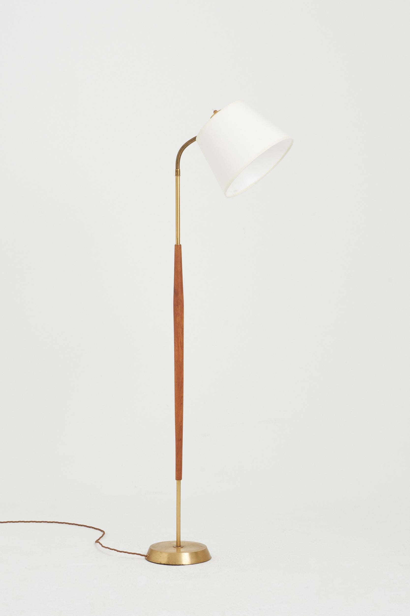 A brass and teak reading floor lamp by Boréns, Borås.
Sweden, circa 1960.