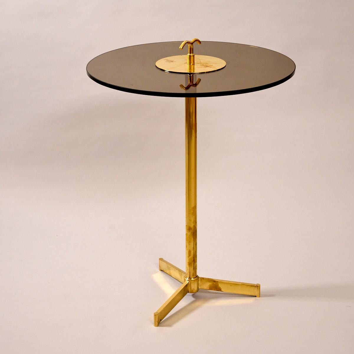 Tripod table in brass and tinted glass. 