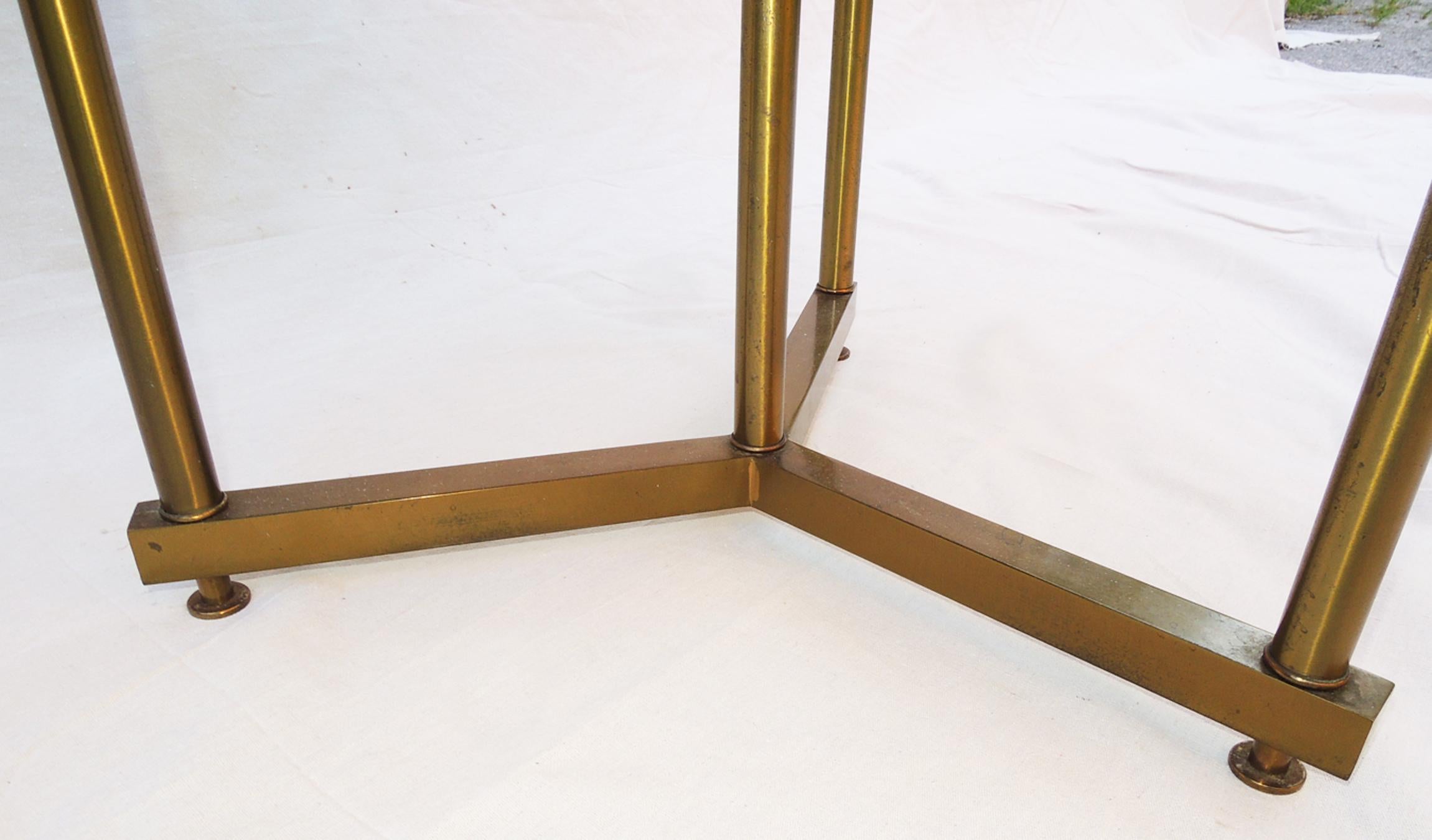 Round gueridon with simple brass legs, flat disc feet floating the Y-frame off the ground.
Italian travertine clean.