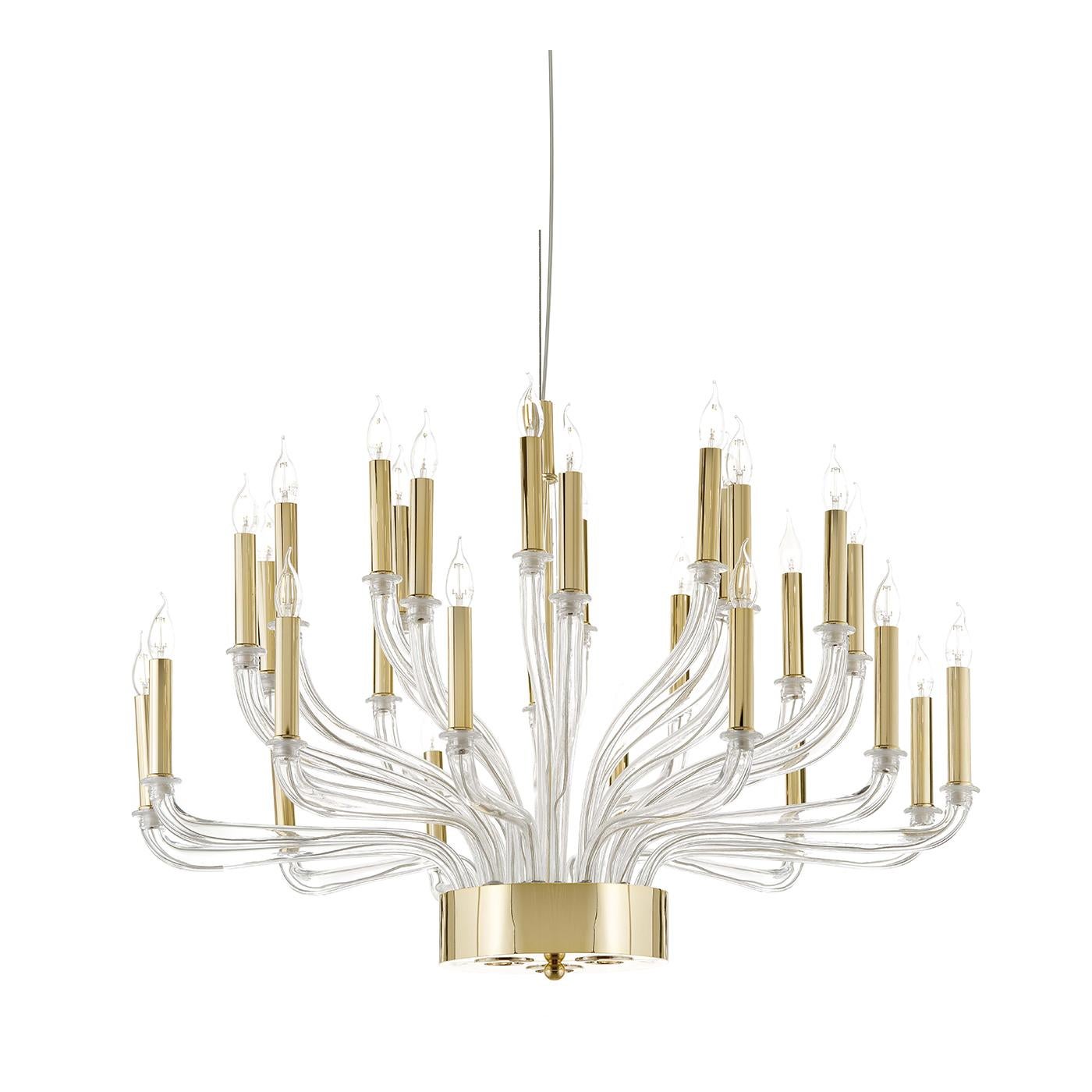 This sumptuous chandelier mixes traditional and noble materials with a modern design, combining sinuous curves in transparent Venetian mouth-blown glass with vertical elements in brushed brass that support the 30 E14 x 5W LED + three GU 10 x 10W LED