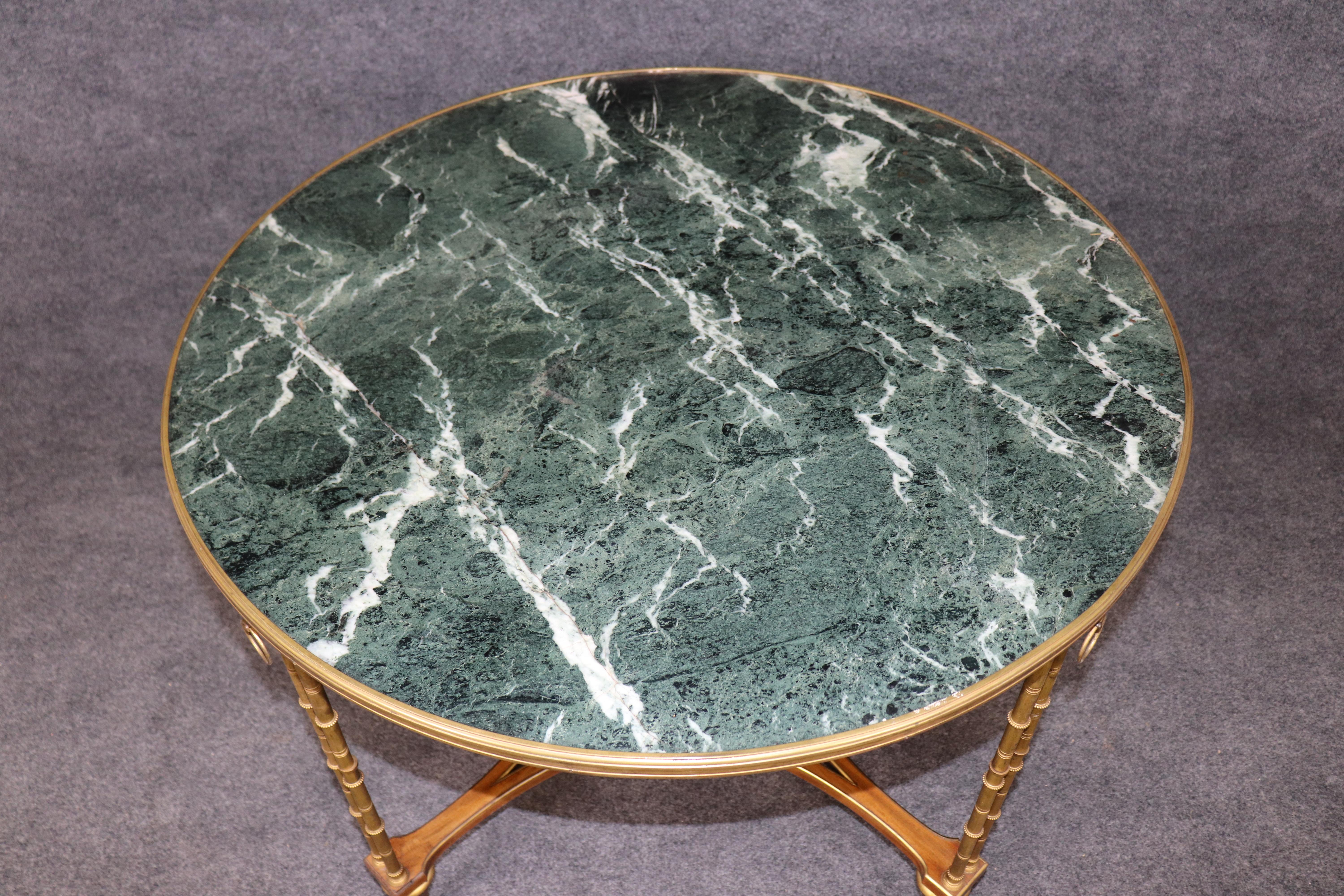 Cette exquise table à plateau de marbre de style Louis XVI est un rare exemple d'art néoclassique à la manière d'Adams Weisweiler, l'un des ébénistes les plus célèbres de la France du XVIIIe siècle. La table présente un riche plateau en marbre vert