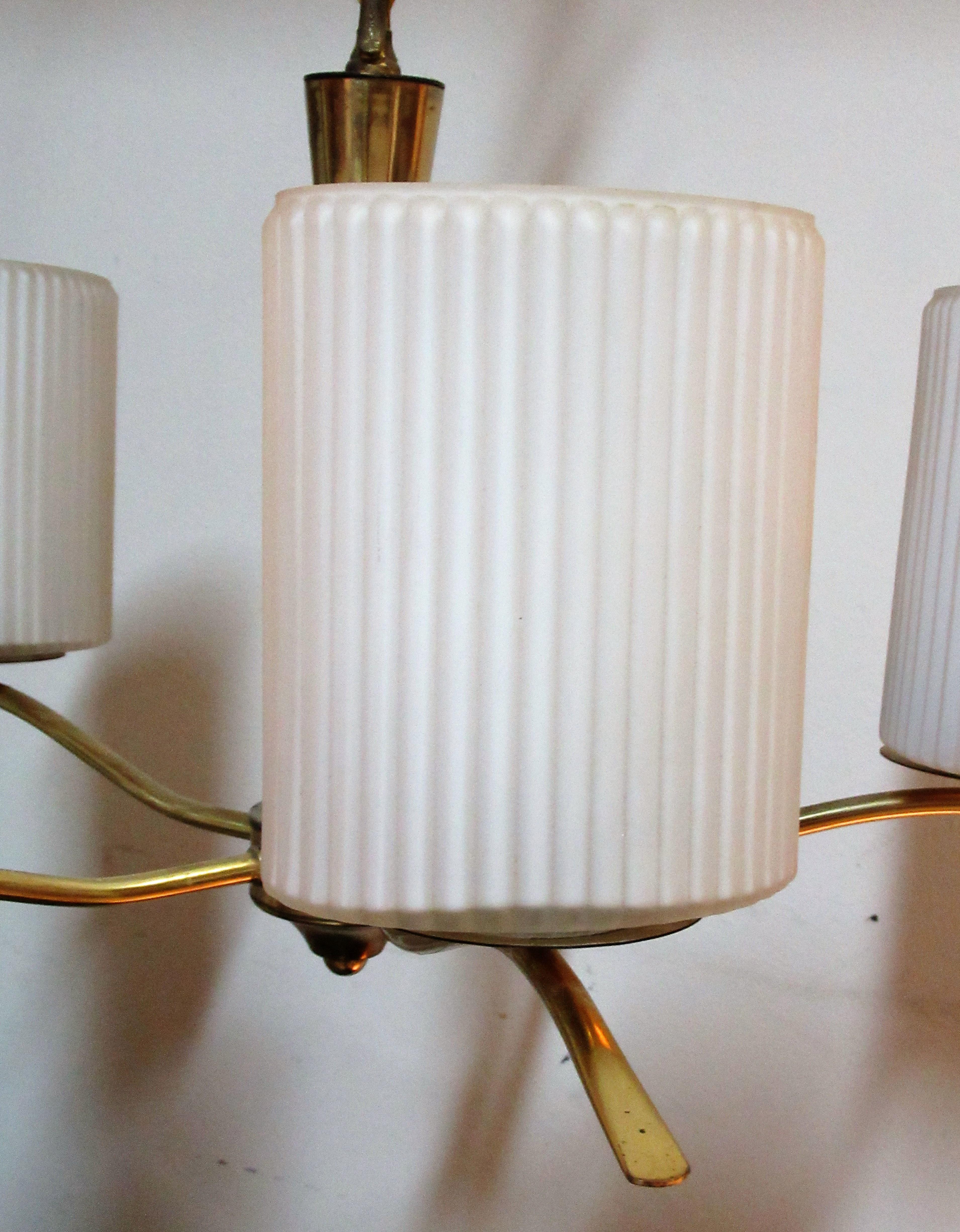 Golden brass five-arm chandelier with fine ribbed white glass cylindrical oval shades, circa 1950-1960 in the Italian modernist style of Gio Ponti. Good quality. Great looking.