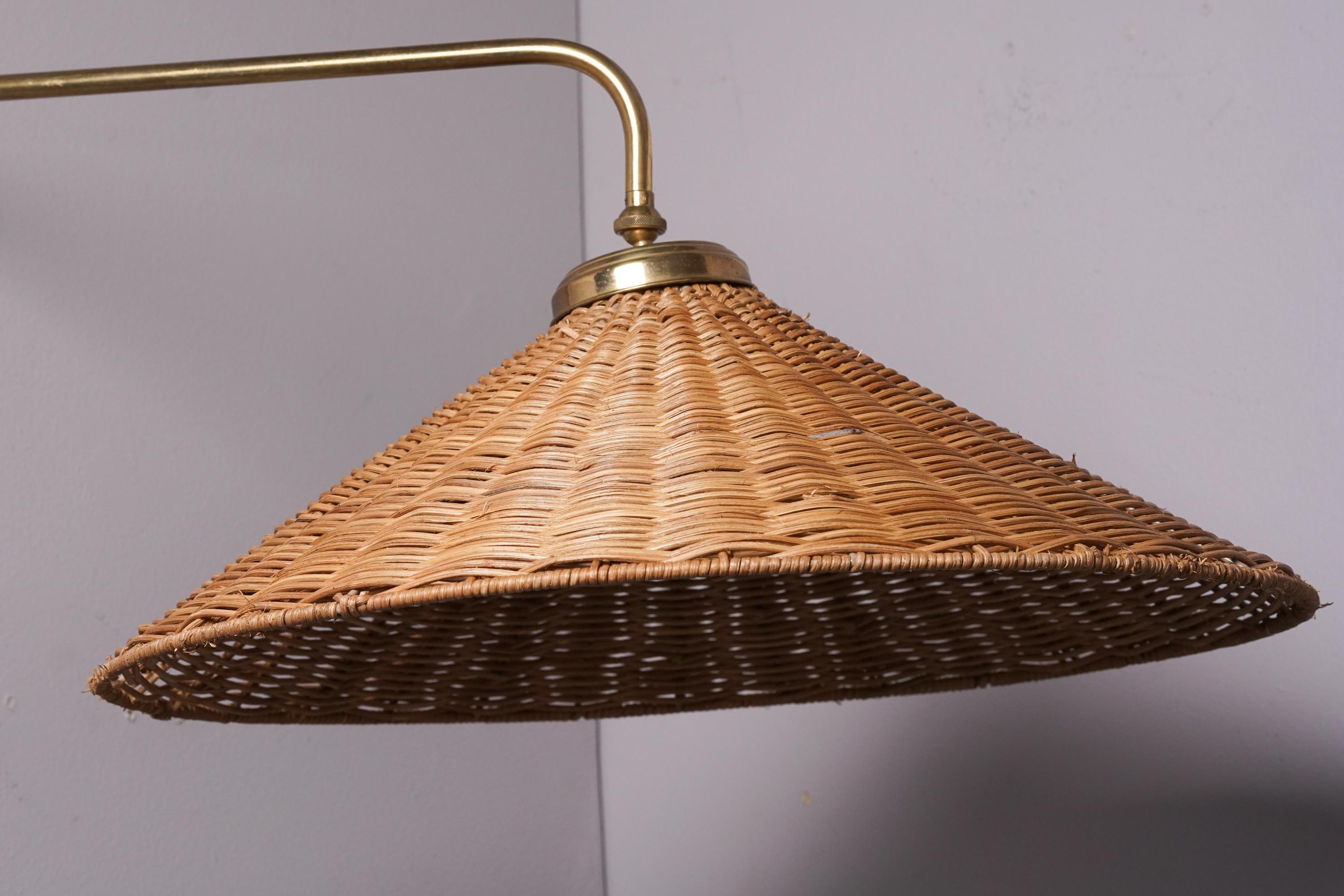 Wall light, manufactured by Itsu Oy, 1950s. Brass frame with wicker lampshade. Marked. Good vintage condition, minor patina consistent with age and use. Classic Scandinavian Modern style. 