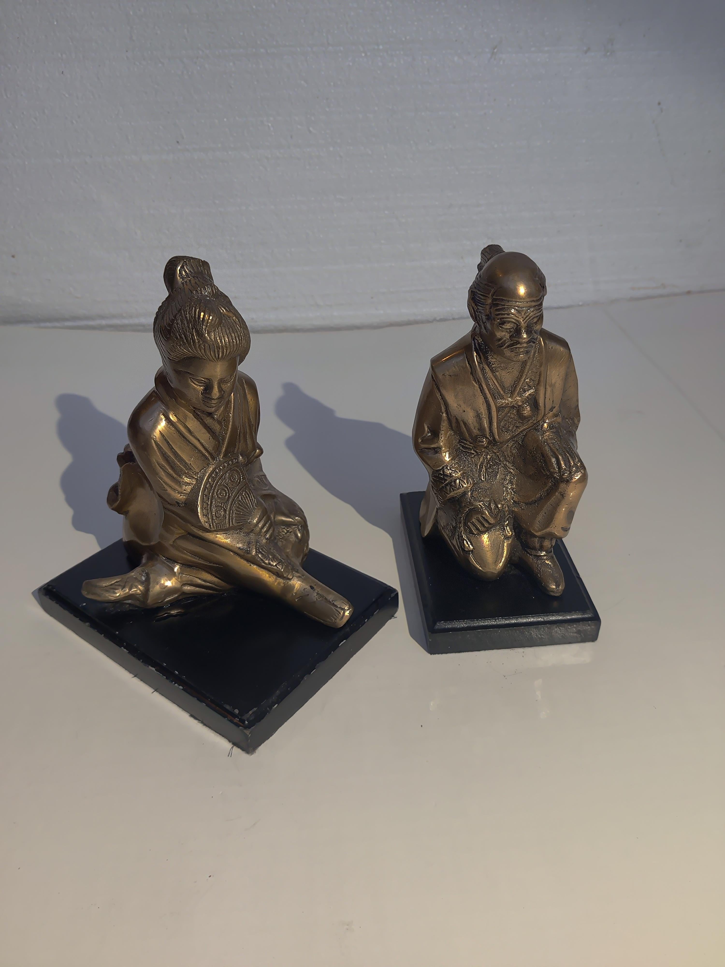 Brass and Wood Asian Bookends
Ceremony Position Asian Male and Geisha Female.
Some wear on wood black bases.
Male dimensions 7H x 4.5L x 2.5W.   Wood base 5 x 3.5.
Female dimensions 7H x  5.5L x 4W.  Wood base 6.5 x 4.75.
