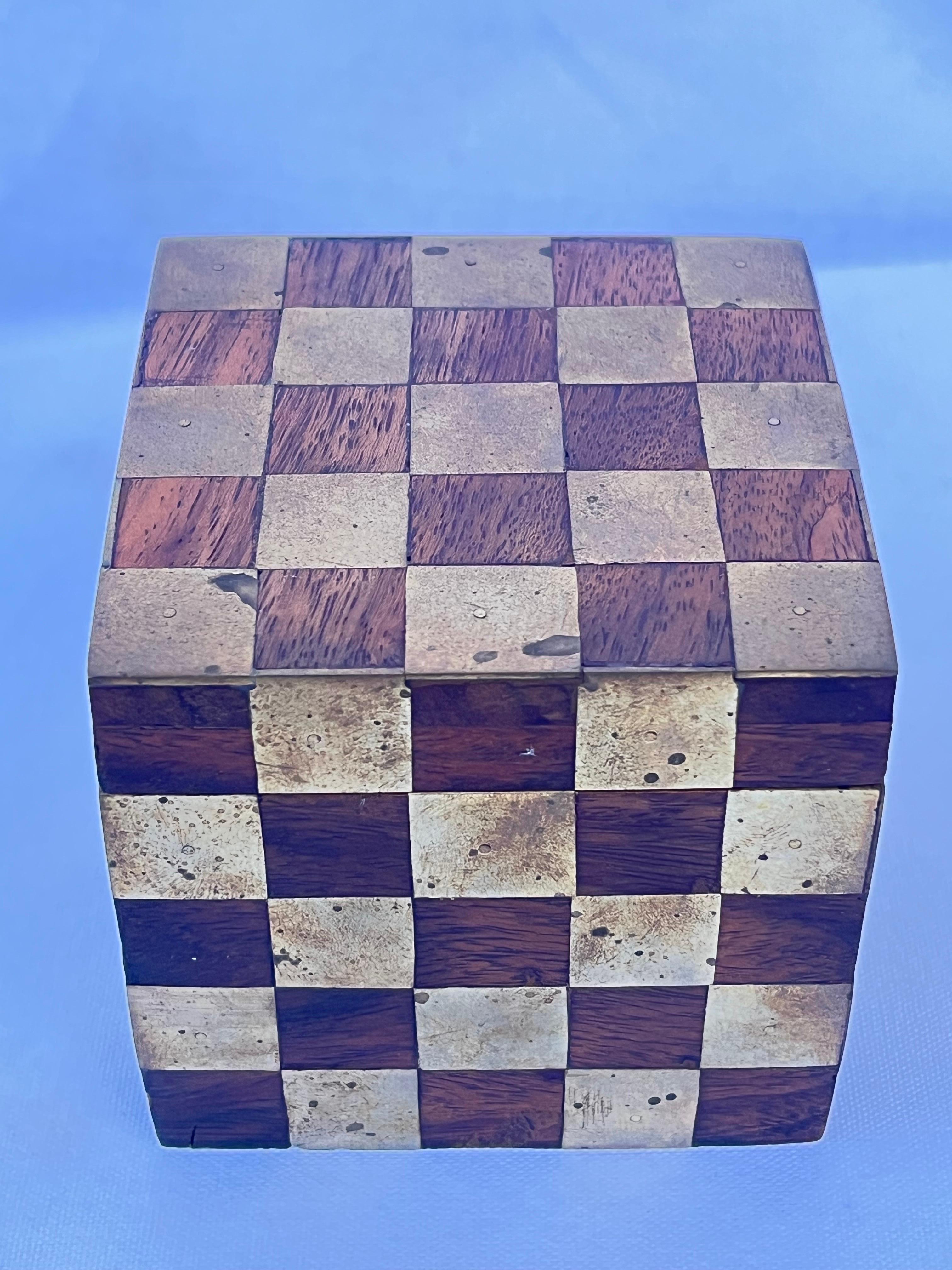 A fantastically geometric checkerboard style lidded cube shaped box or paperweight or desk accessory presented in alternating cubes of brass and wood. It's the perfect hiding spot or stash box for those things you want to keep all to yourself but