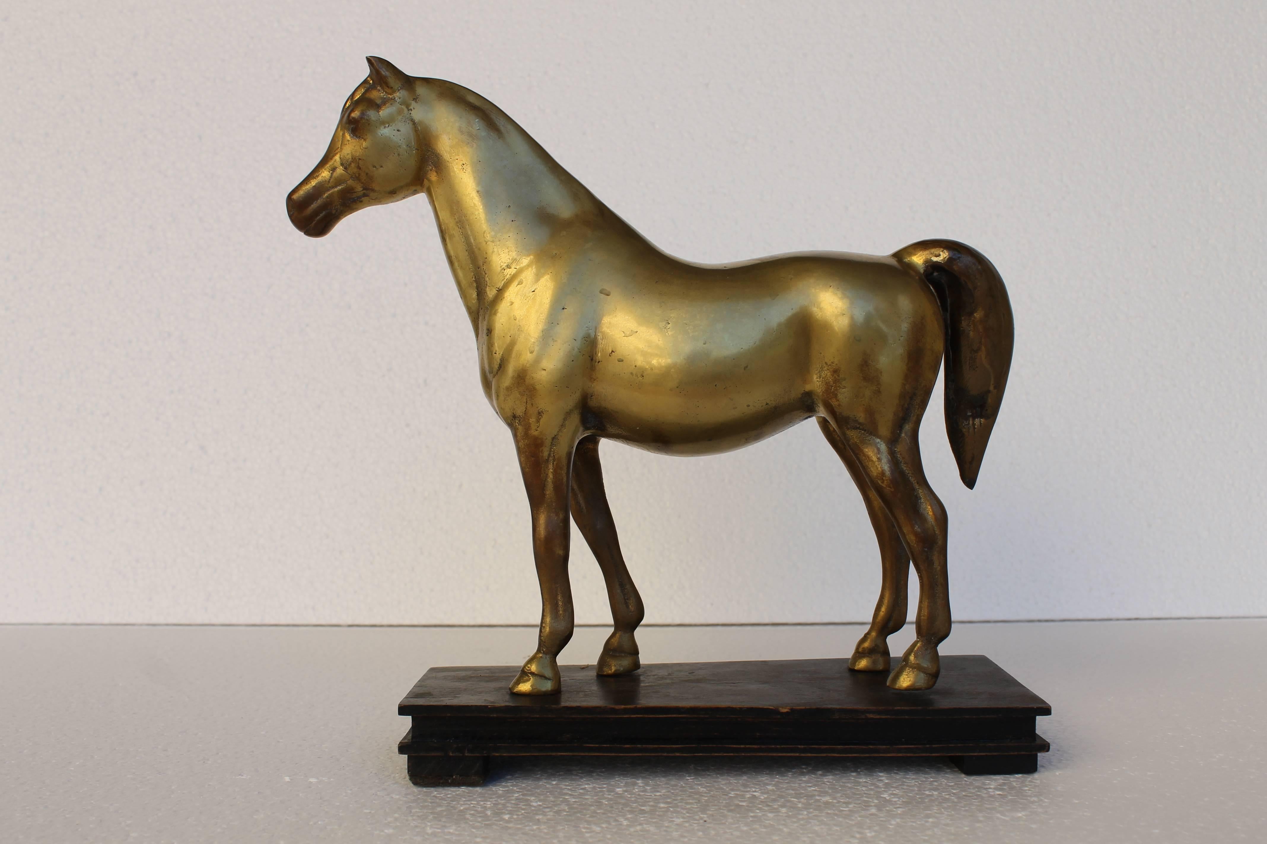 Horse model in brass with ebonized wood base, dated circa 1940.