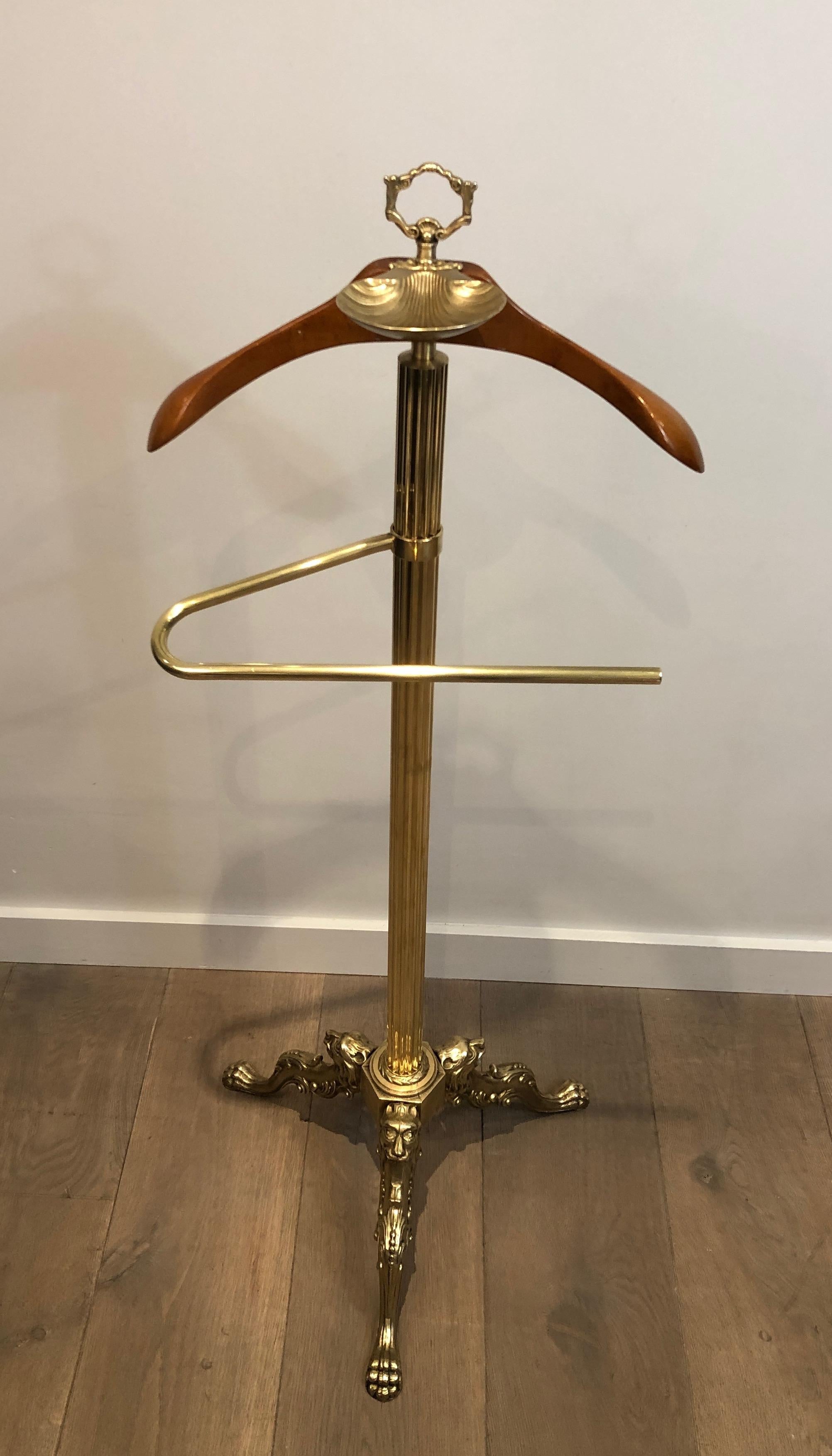 This neoclassicla style valet is made of brass and wood with lion heads and feet. This is a French work, circa 1940.

  
