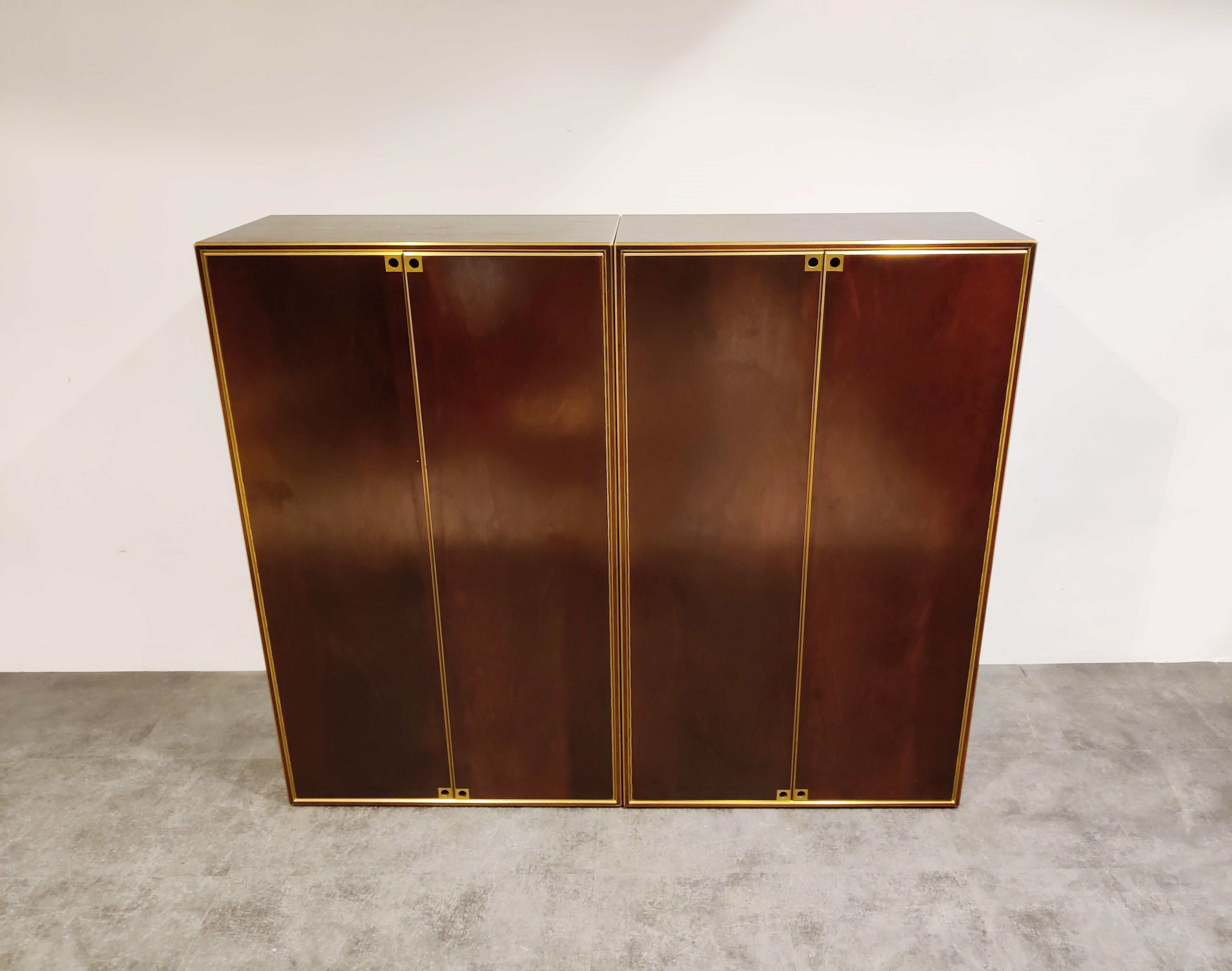 Set of 2 cabinets with wooden panels and brass by Maison Jansen.

The cabinets are very good quality with distinctive Maison Jansen handles. 

They can be used combined next to each other or separately. 

Very good condition.

1960s -