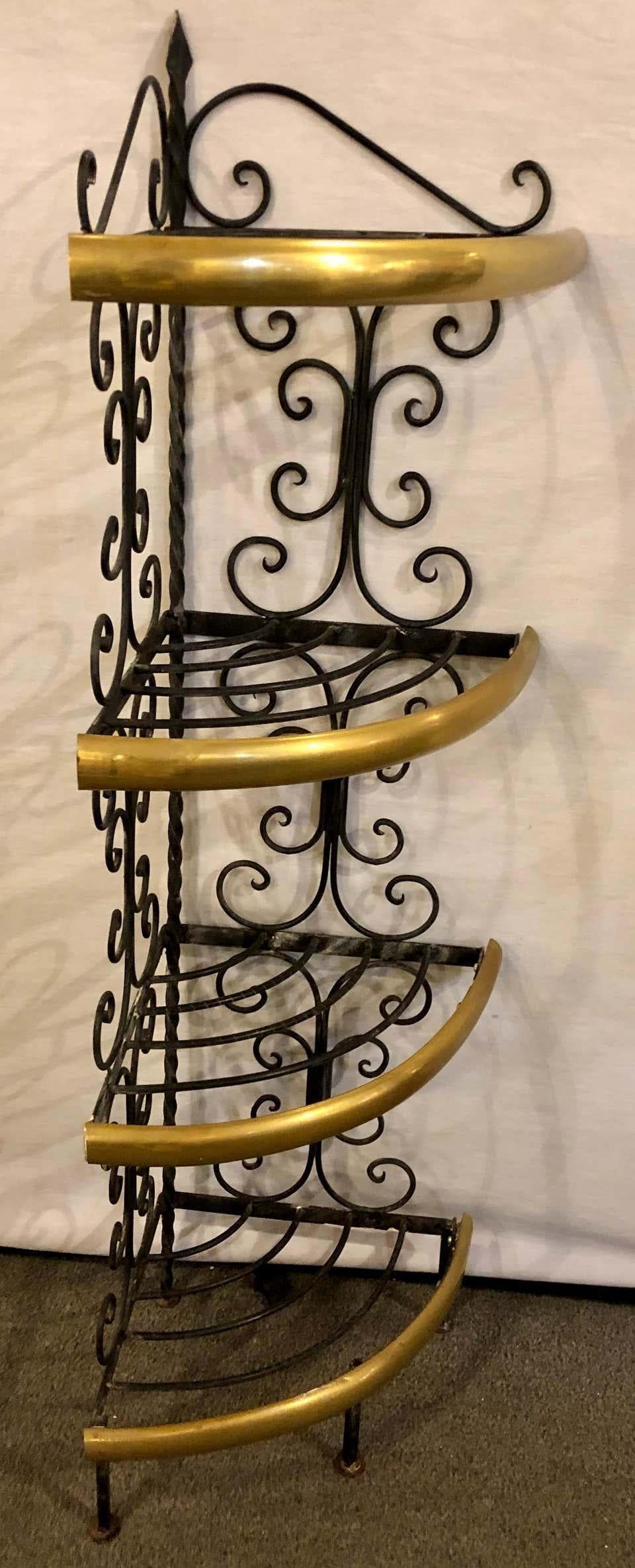 Brass and wrought iron four-tier diminutive bakers rack in demilune shape. A sweet addition to any kitchen or serving area is this sleek and stylish bakers rack. The wrought iron frame having brass bow front mounts. The whole with four shelves for
