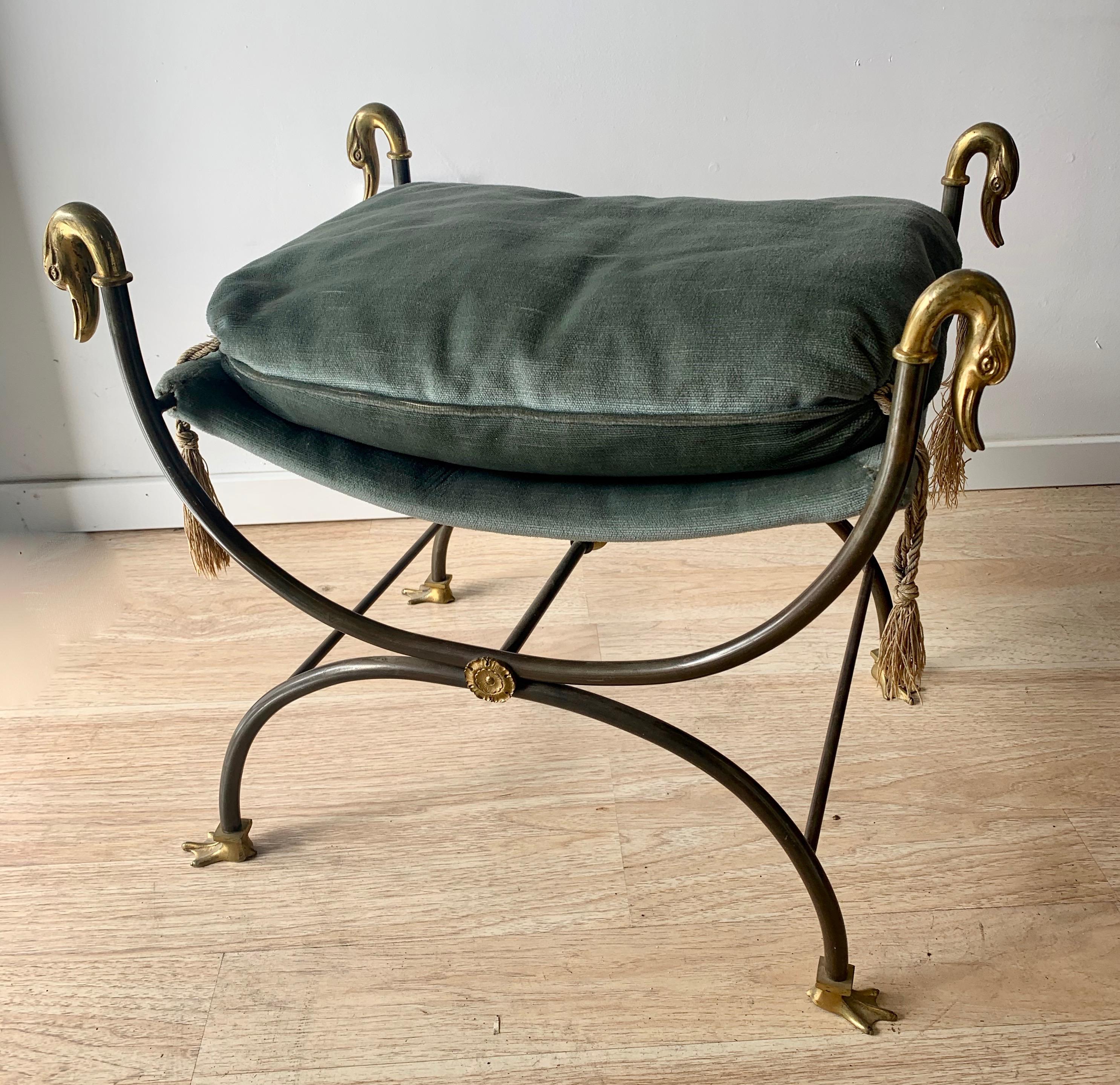 A wonderful vanity stool with geese head brass finials, and brass duck feet. The down cushion is loose and detailed with tassels. The look is very similar to Maison Jansen and will bring a very sophisticated look to any dressing or bathroom.

The