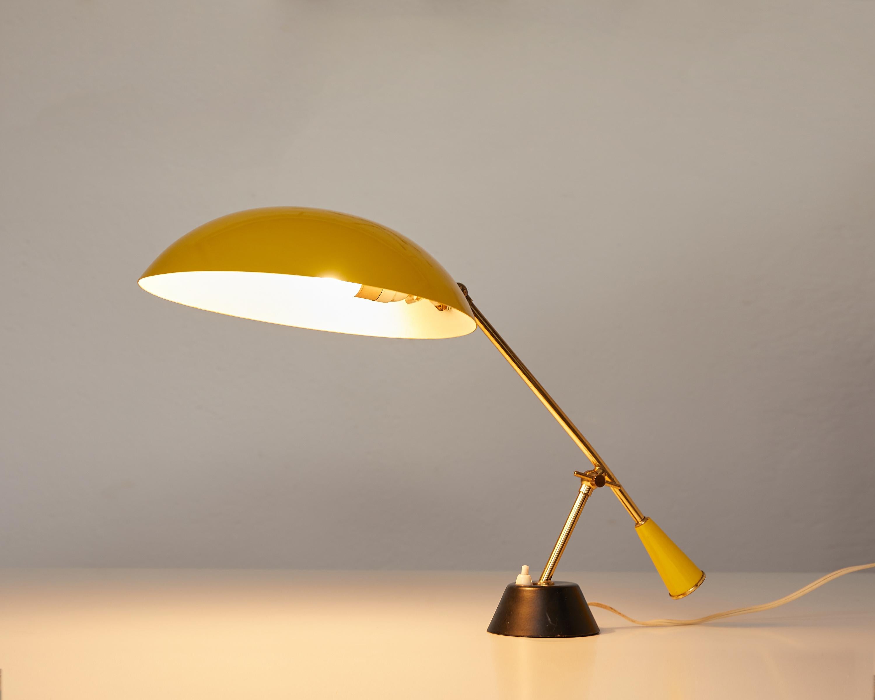 Brass and yellow lacquered metal table lamp with counterweight, Switzerland, 1950.

This lovely table or desk lamp is attributed to BAG Turgi, the most famous lighting company in Switzerland. The quality of fabrication and the well finished